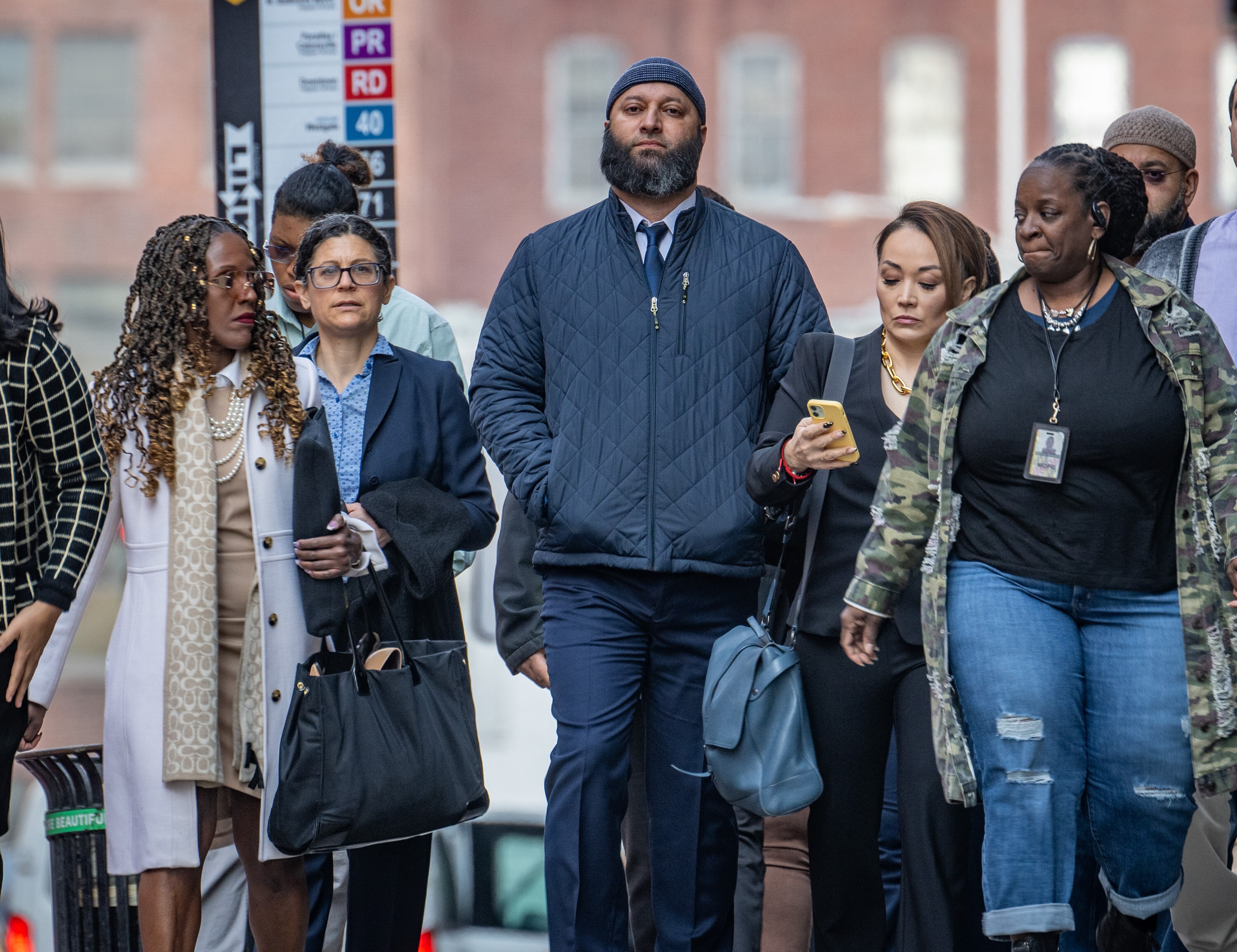 Adnan Syed, center, arrives at the Clarence M. Mitchell Jr. Courthouse on Wednesday for a hearing to reduce his murder sentence under the Juvenile Restoration Act. 