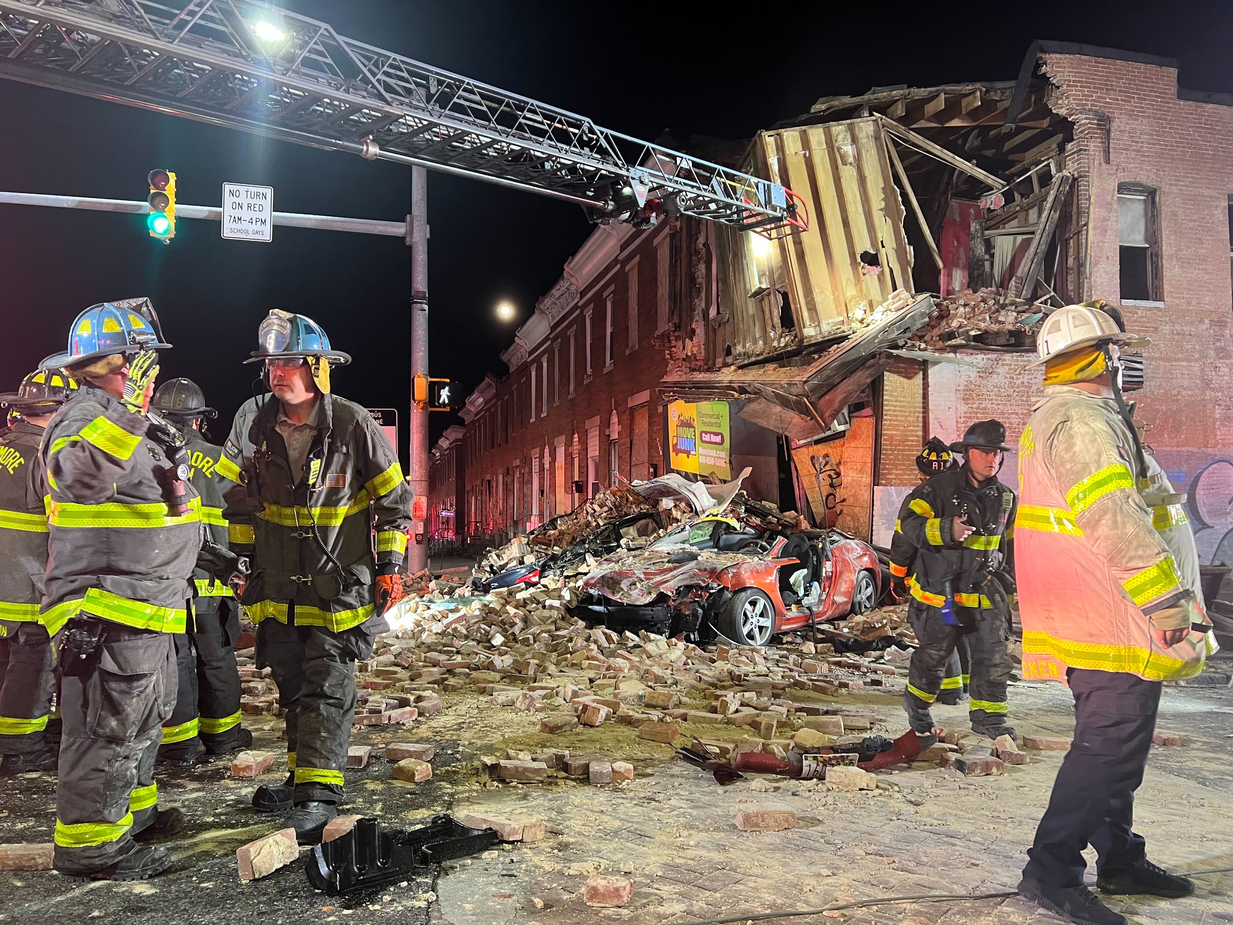 Firefighters respond to a partial building collapse at the intersection of E. North Avenue and N. Wolfe Street after a car hit a building.