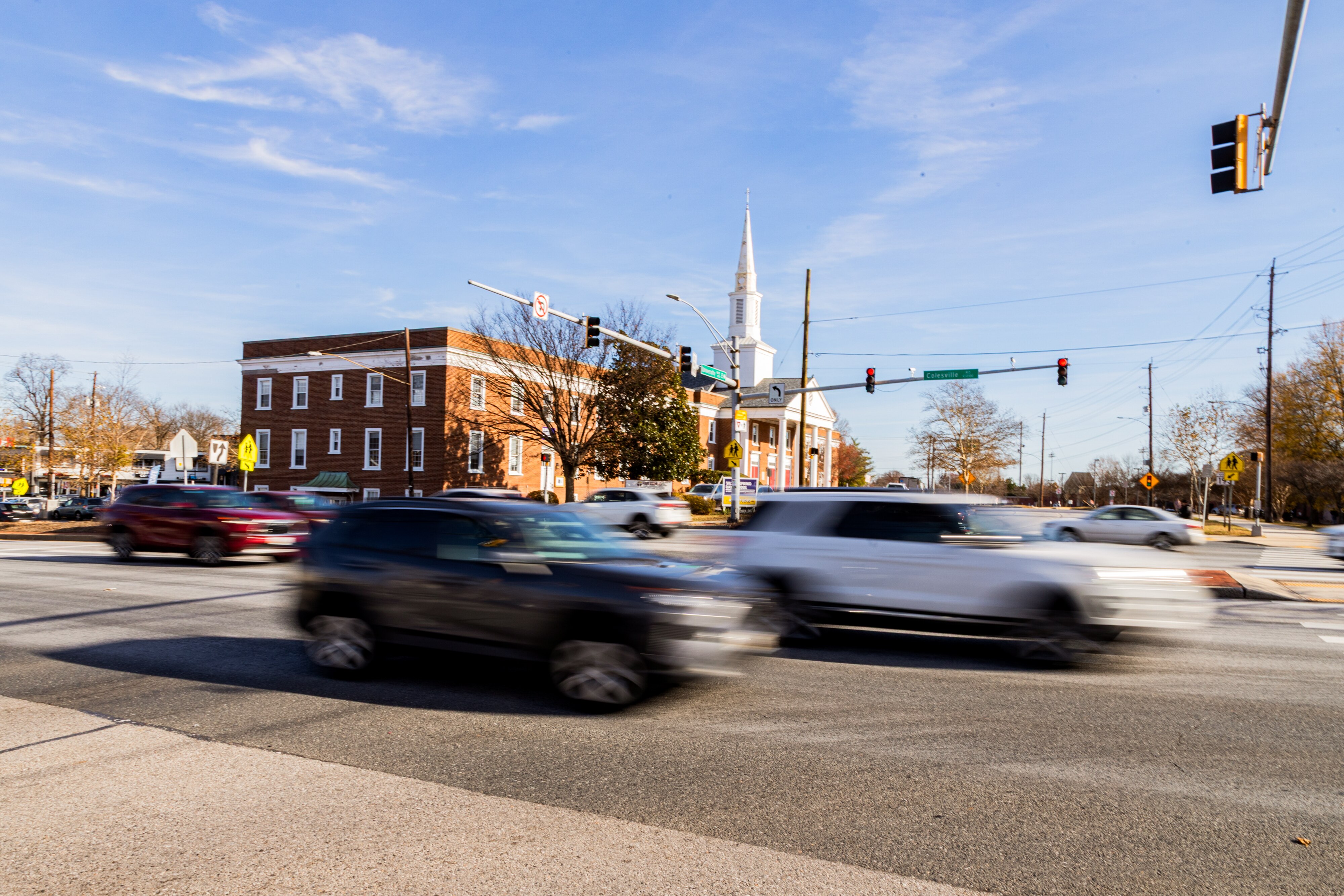 Cars drive through the intersection of University Boulevard West and Colesville Road in Silver Spring.