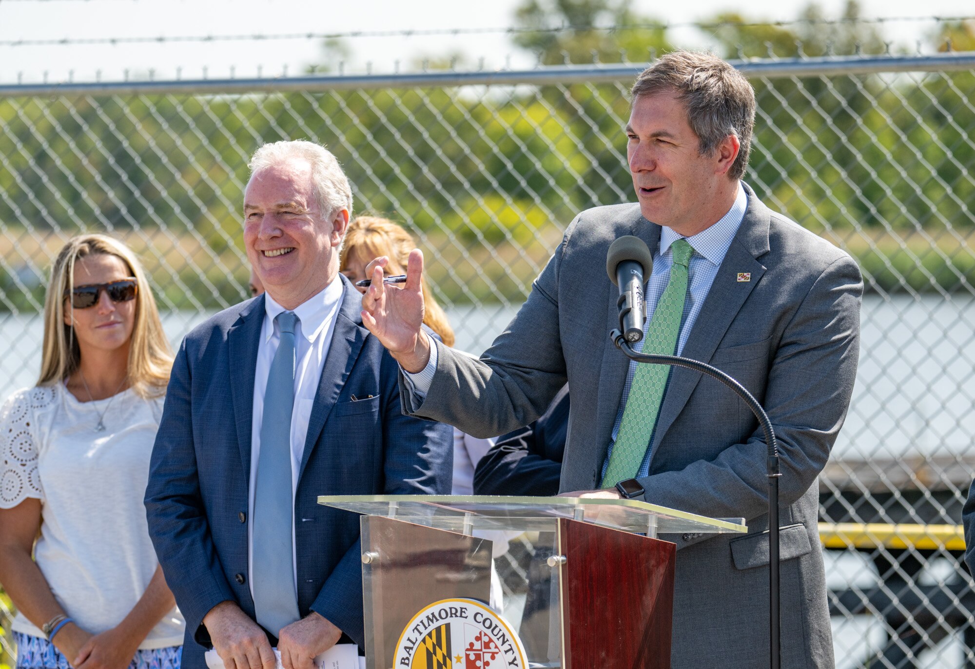 Baltimore County Executive Johnny Olszewski Jr. speaks at a press conference announcing the creation of a new county park at the site of the former C.P. Crane power plant, a source of pollution in the Bowley's Quarters area for decades. With him are U.S Sen Chris Van Hollen and Senaca Park Improvement Association President Tara Gebhardt