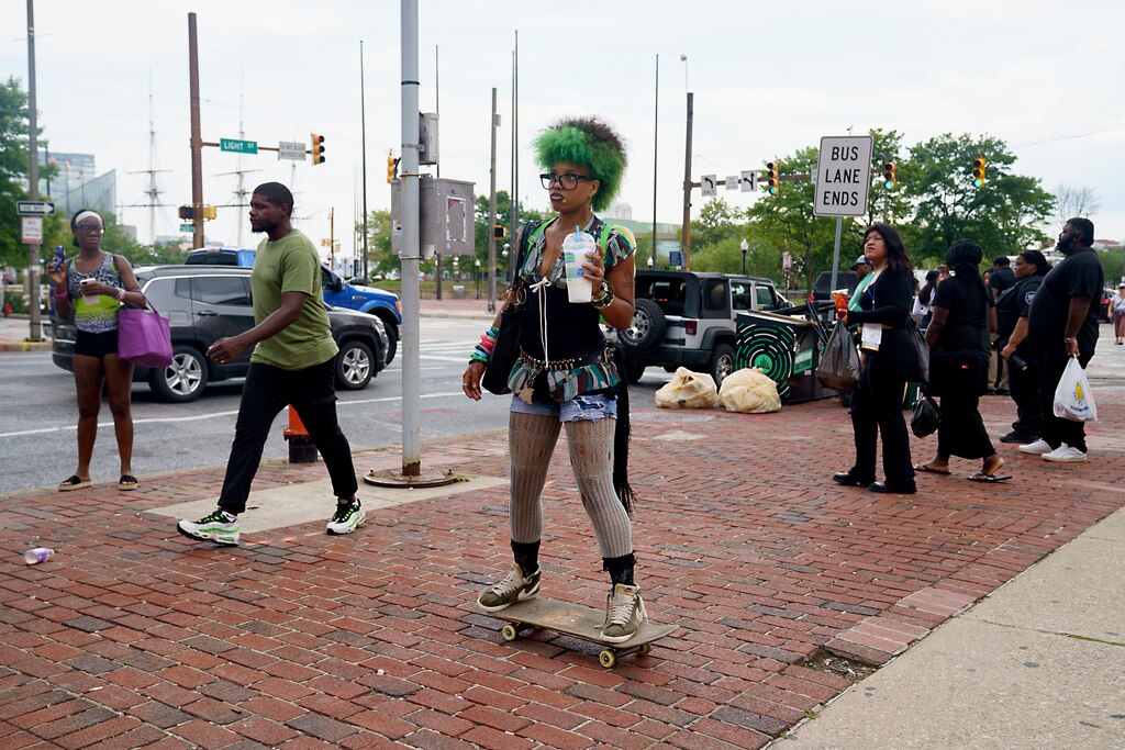 Thursday, Aug. 14, 2025 — Star Taylor sips her slushy as she waits for her bus transfer. Baltimore City, Md.