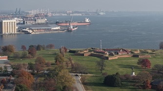 Baltimore Police block the road at East Fort Avenue leading to Fort McHenry on Friday, after sending its bomb squad as a safety measure after crews dug up an old explosive device.