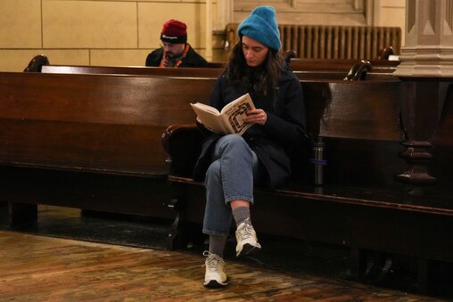 Dilara Gostolupce browses through some of the books on display during the Ivy Bookshop’s pop-up event inside the Mount Vernon Place United Methodist Church and Asbury House in Baltimore, Md. on Thursday, December 4, 2025.