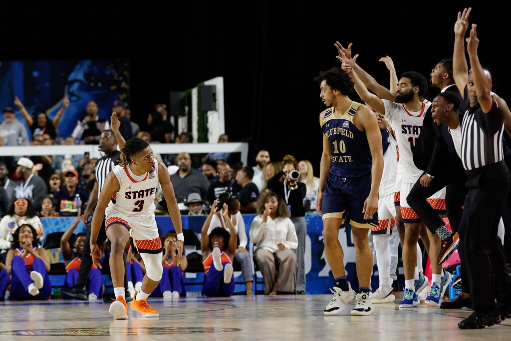 Virginia State guard Clint Wright Jr. (3) celebrates his made three point basket as Bluefield State forward Romeo Aquino (10) looks on during the second half of the CIAA menβs final college basketball game, Saturday, Mar. 1, 2025, in Baltimore, Md.