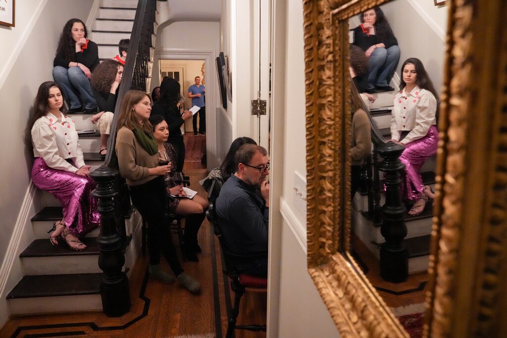 Pianist Ramilya Saubanova, bottom left, and other attendees listen as the Joshua Espinoza Trio performs at a Union Square Soirée in Baltimore, Md. on Friday, January 31, 2025. For a year now, a neighbor in Union Square has hosted intimate music concerts in his historic home’s salon to serve as a platform for newer artists and to share music with the community.