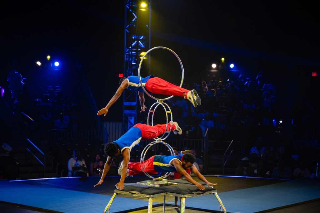 SUNDAY, AUGUST 24TH, 2025 - Three members of the Hoop Divers team leap through tiered hoops during a UniverSoul Circus show in Baltimore, MD.