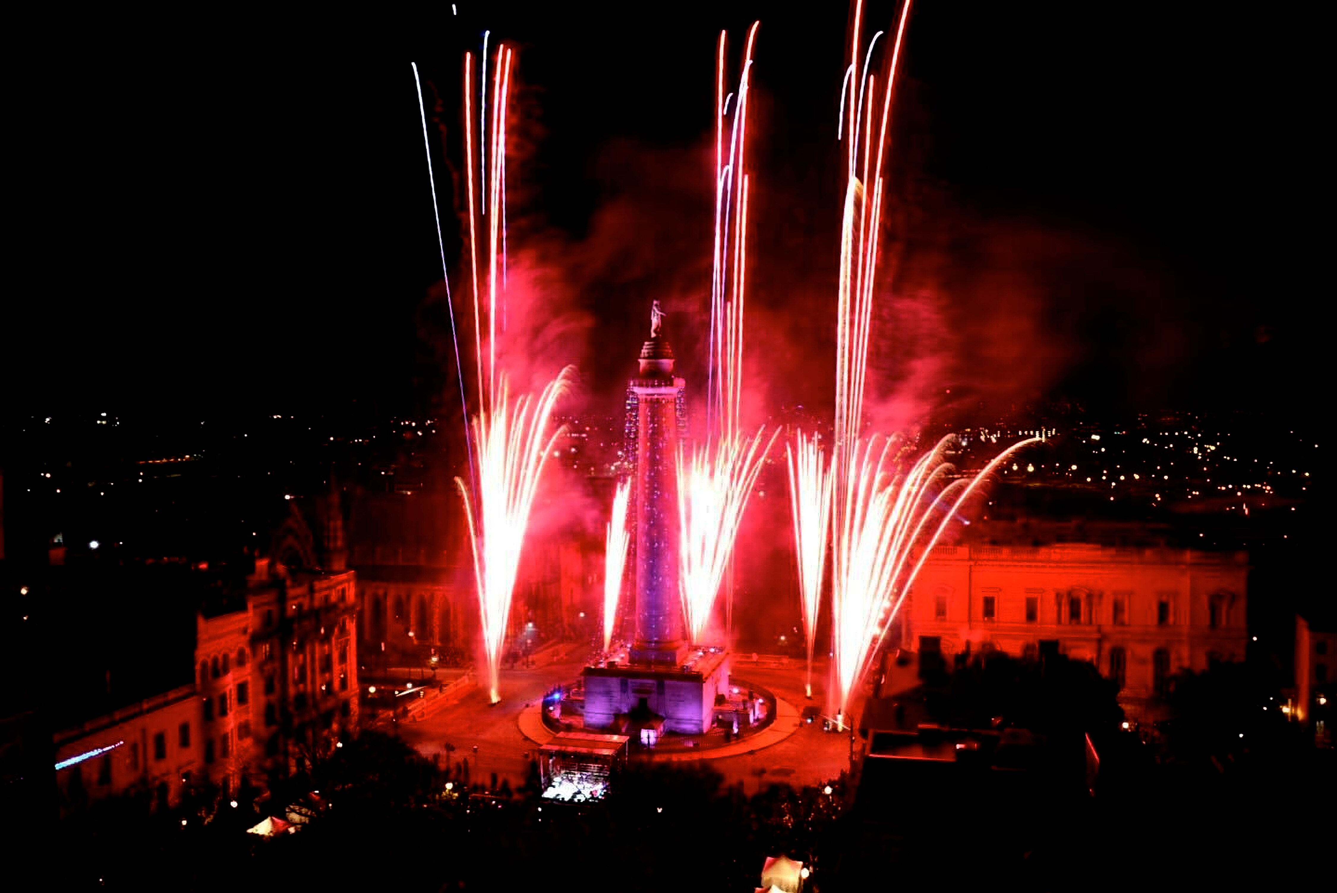 Fireworks ignite the sky at the 51st Monument Lighting in Mount Vernon Thursday night, kicking off the start of December’s holiday season, seen from Topside in hotel Revival in Baltimore.