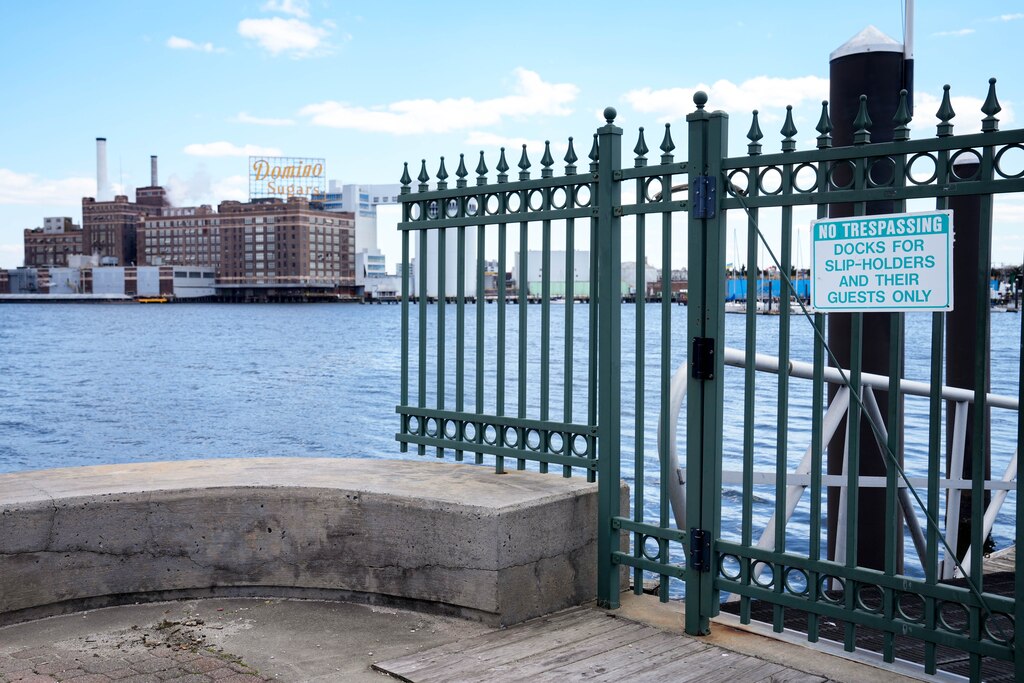 The Domino Sugar refinery visible from the end of the dock at Harborview Marina in Baltimore, Md. on Wednesday, March 26, 2025.