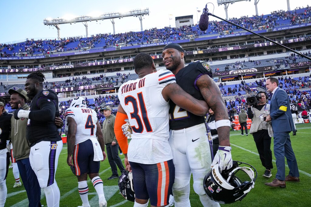 Baltimore Ravens running back Derrick Henry (22) embraces Chicago Bears safety Kevin Byard III (31) following their win at M&T Bank Stadium in Baltimore, Md., on Sunday, Oct. 26, 2025.