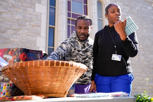 Brandon Gray, left, and Shatera Peay choose free potholders from a large selection during a Thanksgiving holiday meal giveaway at Trinity Episcopal Church in Towson, Md., on Monday, November 24, 2025. The Assistance Center of Towson Churches organized the event, which was also held in 2024.