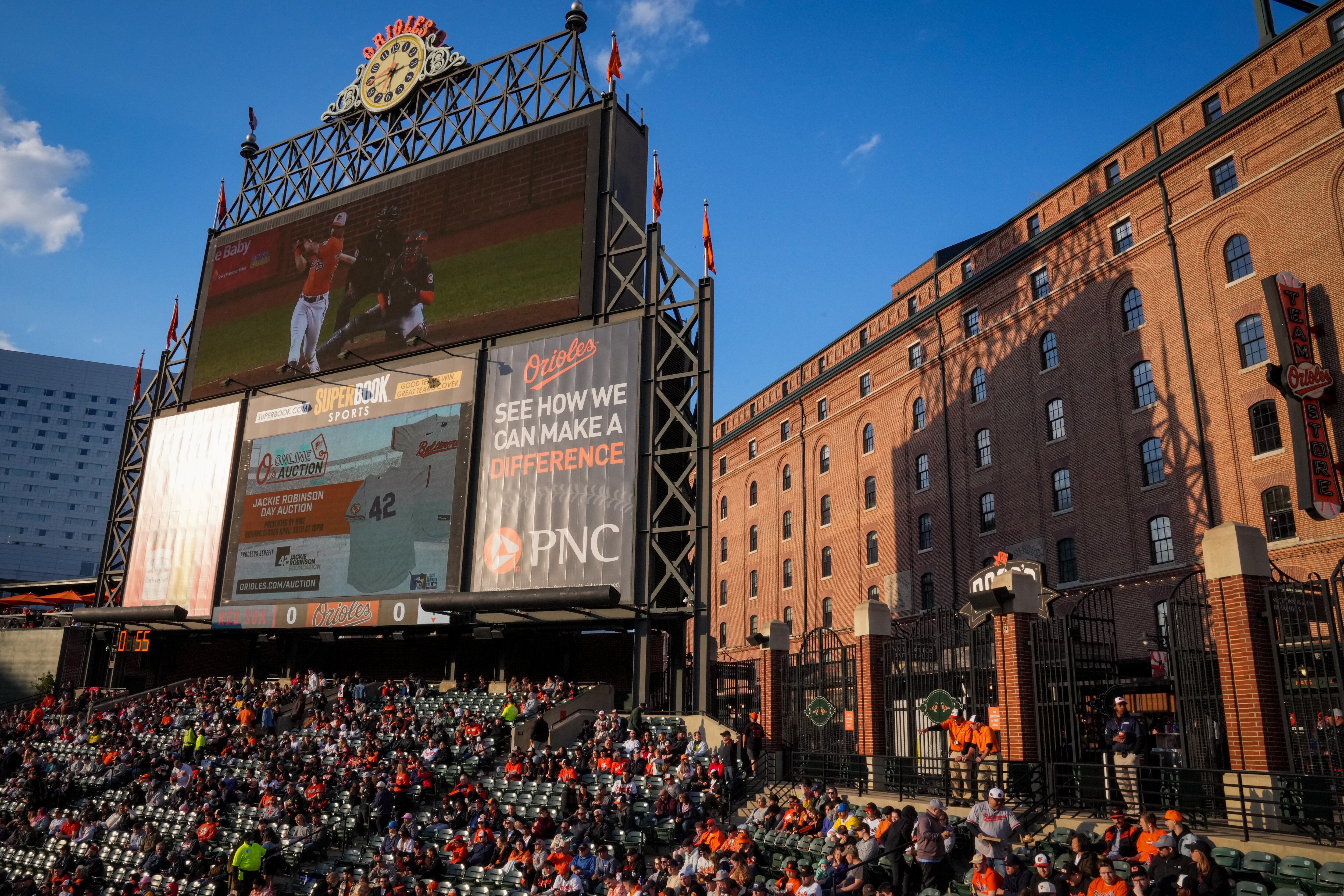 Baltimore Orioles and Boston Red Sox fans in seats near the outfield watch a baseball game at Camden Yards on Monday, April 24.