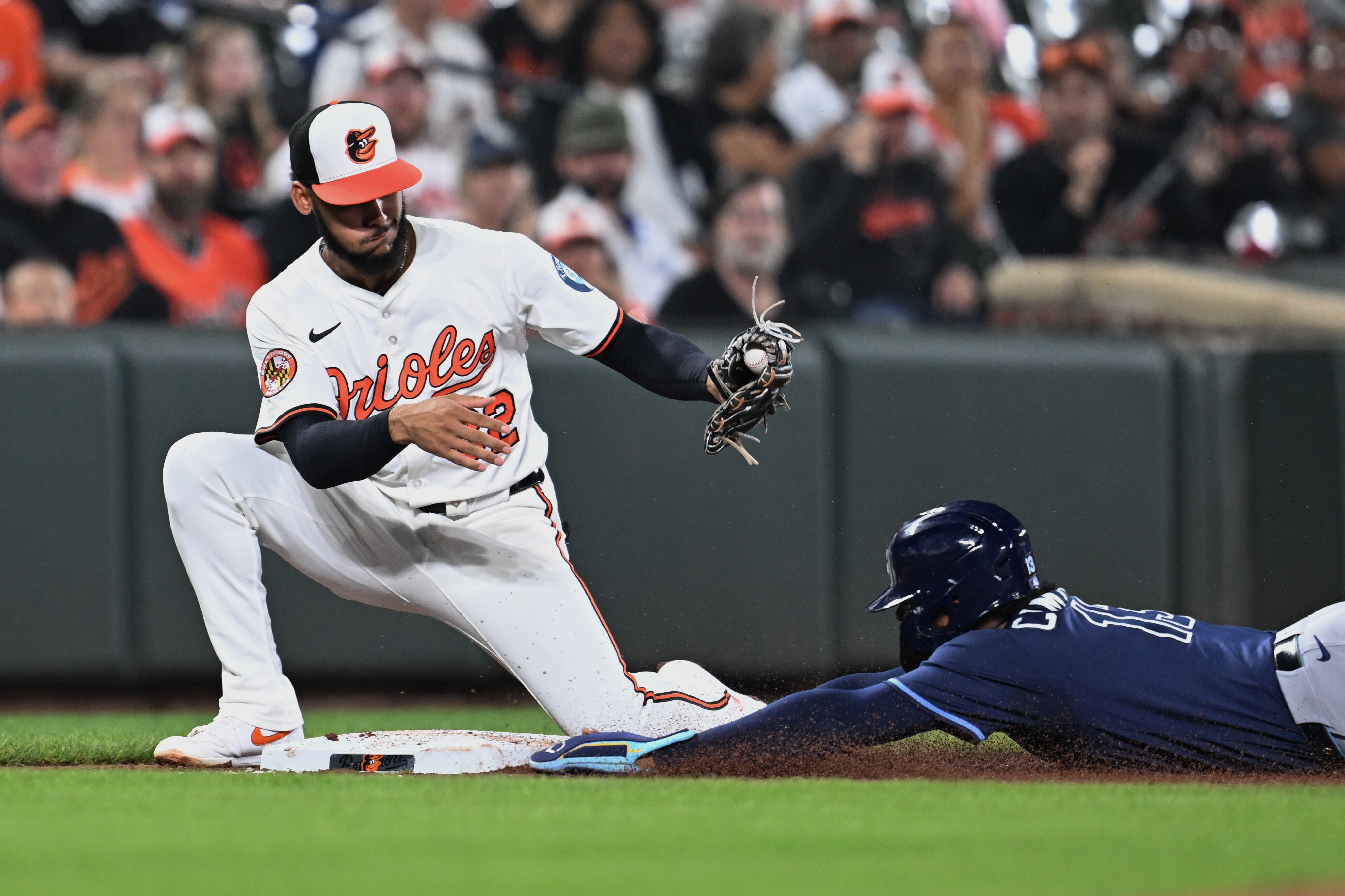Tampa Bay Rays' Junior Caminero slides safely into third base on a single by Richie Palacios in the third inning.