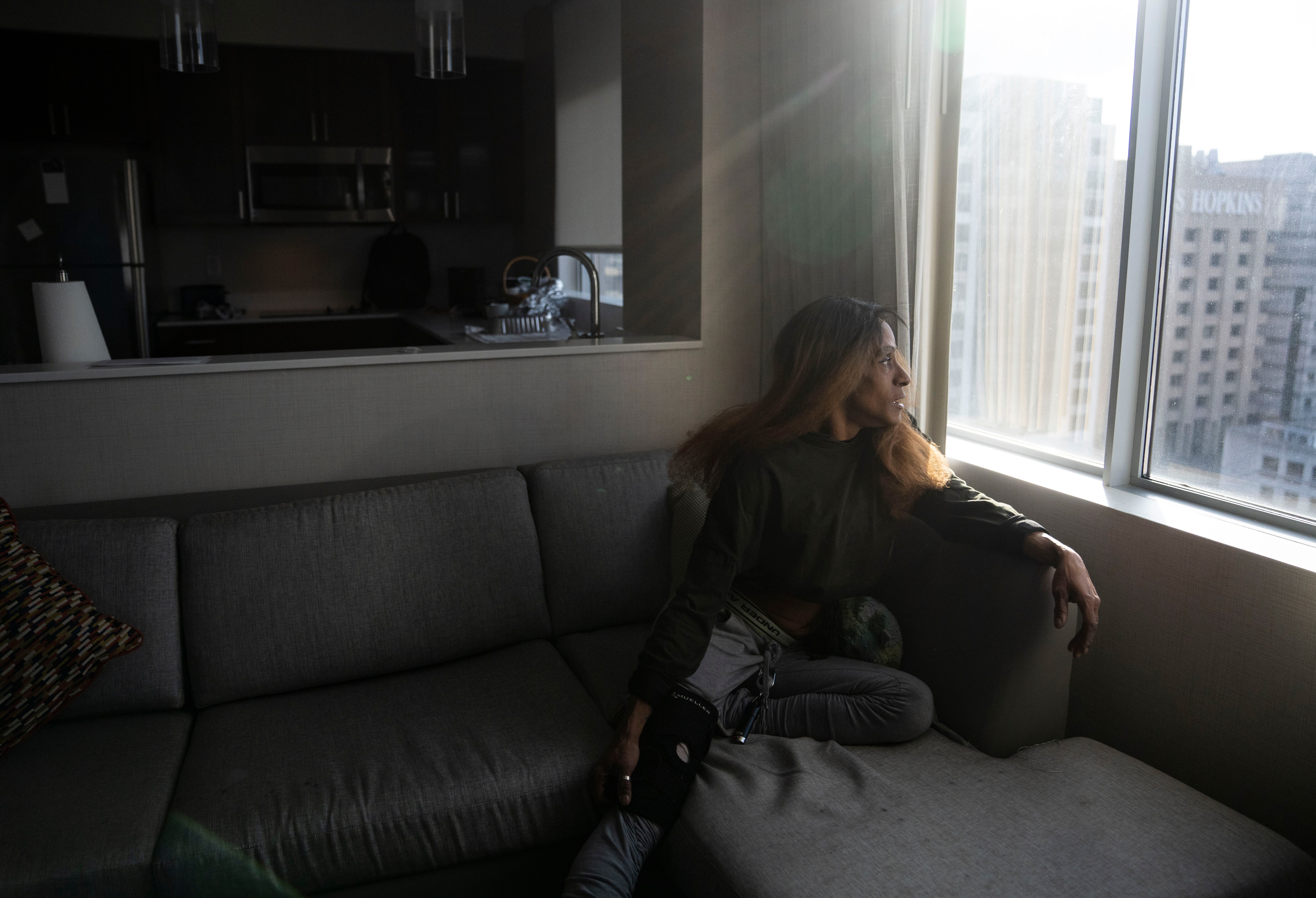 Melissa, who asked to withhold her last name to protect her son’s privacy, poses for a portrait inside her Baltimore hotel on Tuesday, Nov. 28, 2023. Melissa is facing eviction after a housing nonprofit stopped paying her rent earlier this year.