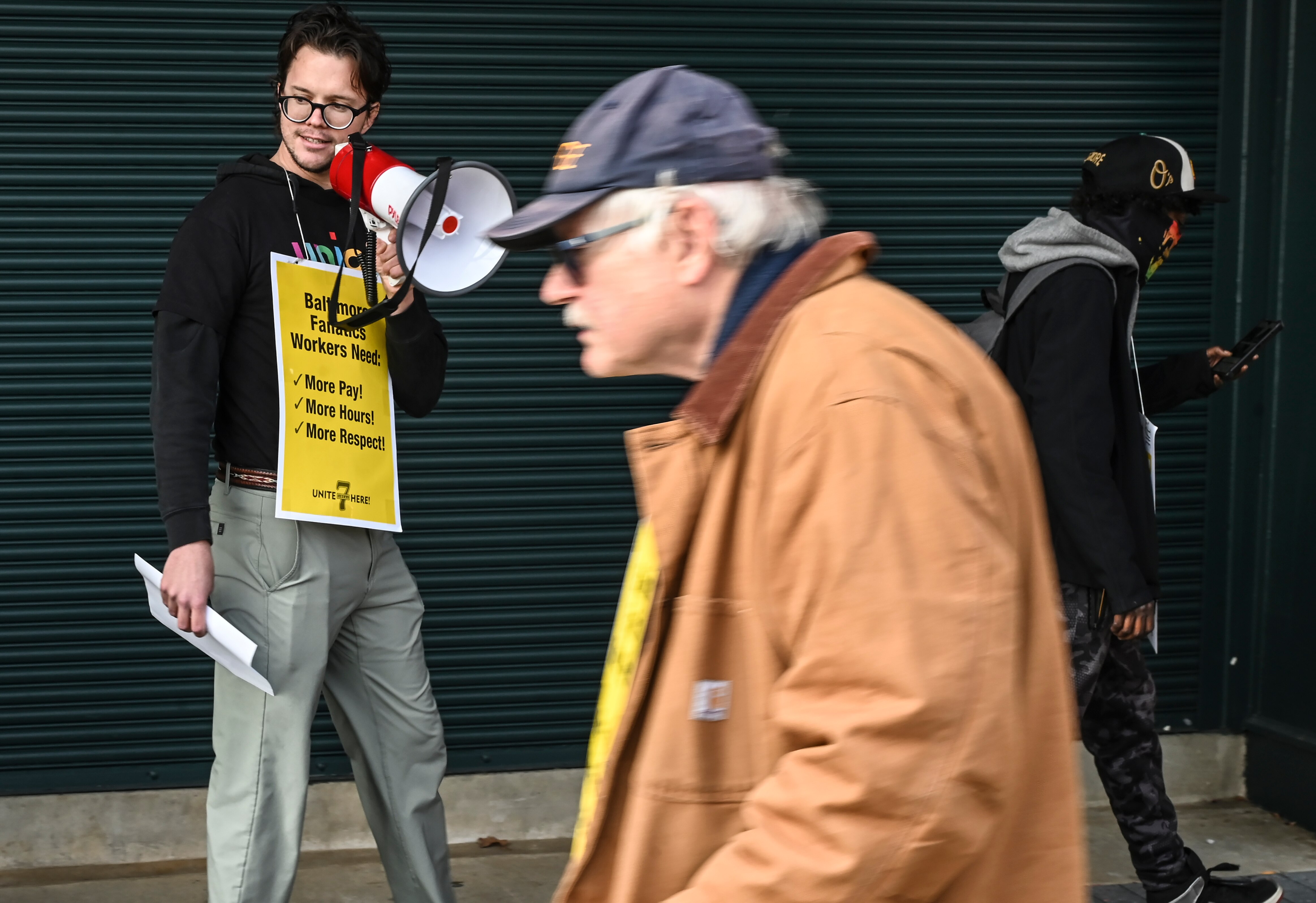 A member of Unite Here Local 7 and Fanatics employee speaks at the picket line in front of the Orioles Team Store around noon on Black Friday.
