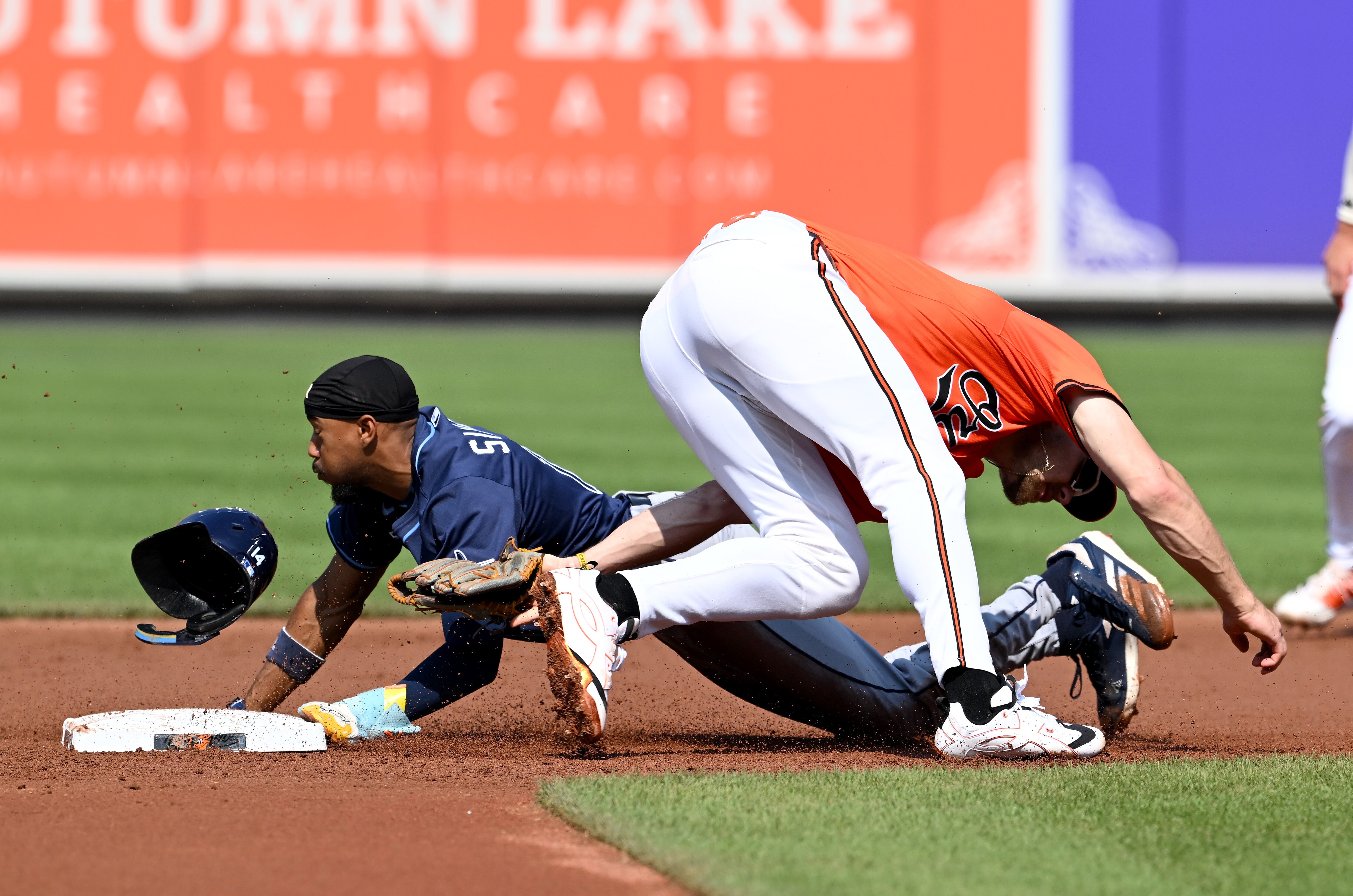 Chandler Simpson of the Rays steals second base in the first inning as the throw gets away from Orioles shortstop Gunnar Henderson.