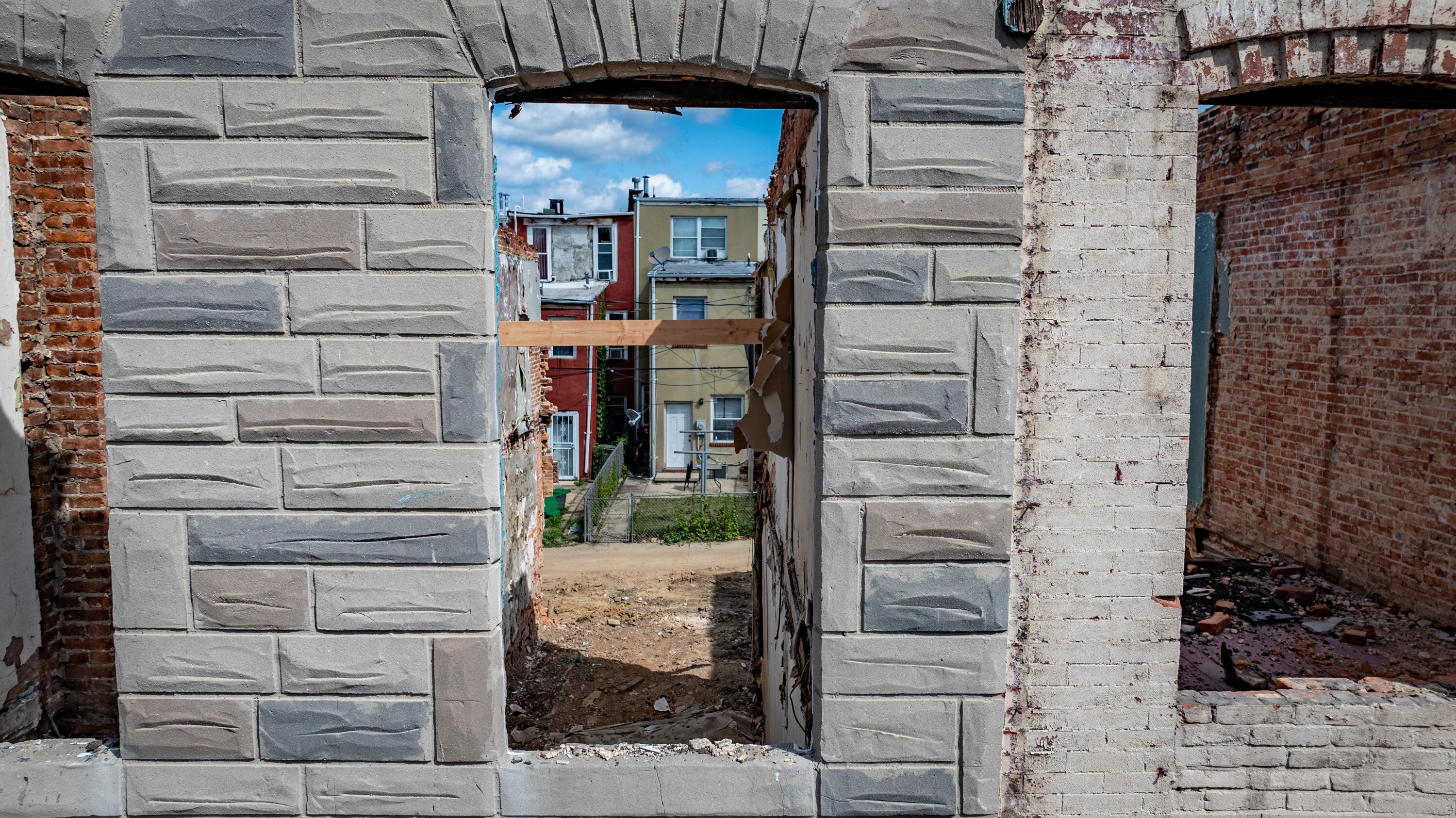 Contractors with ReBUILD Metro in Baltimore work in August to revitalize a block of Mura Street where the majority of homes are vacant.