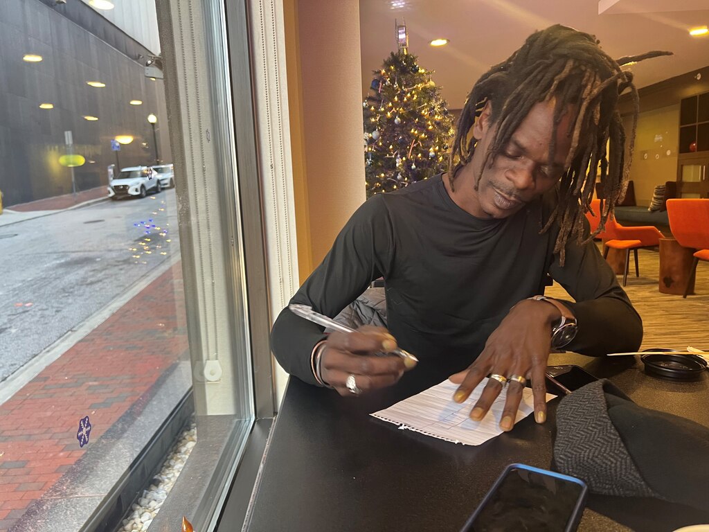 Colin Williams sketches a "perfect" house for him that he saw while walking in Hampden. It includes a storefront and a wraparound patio.