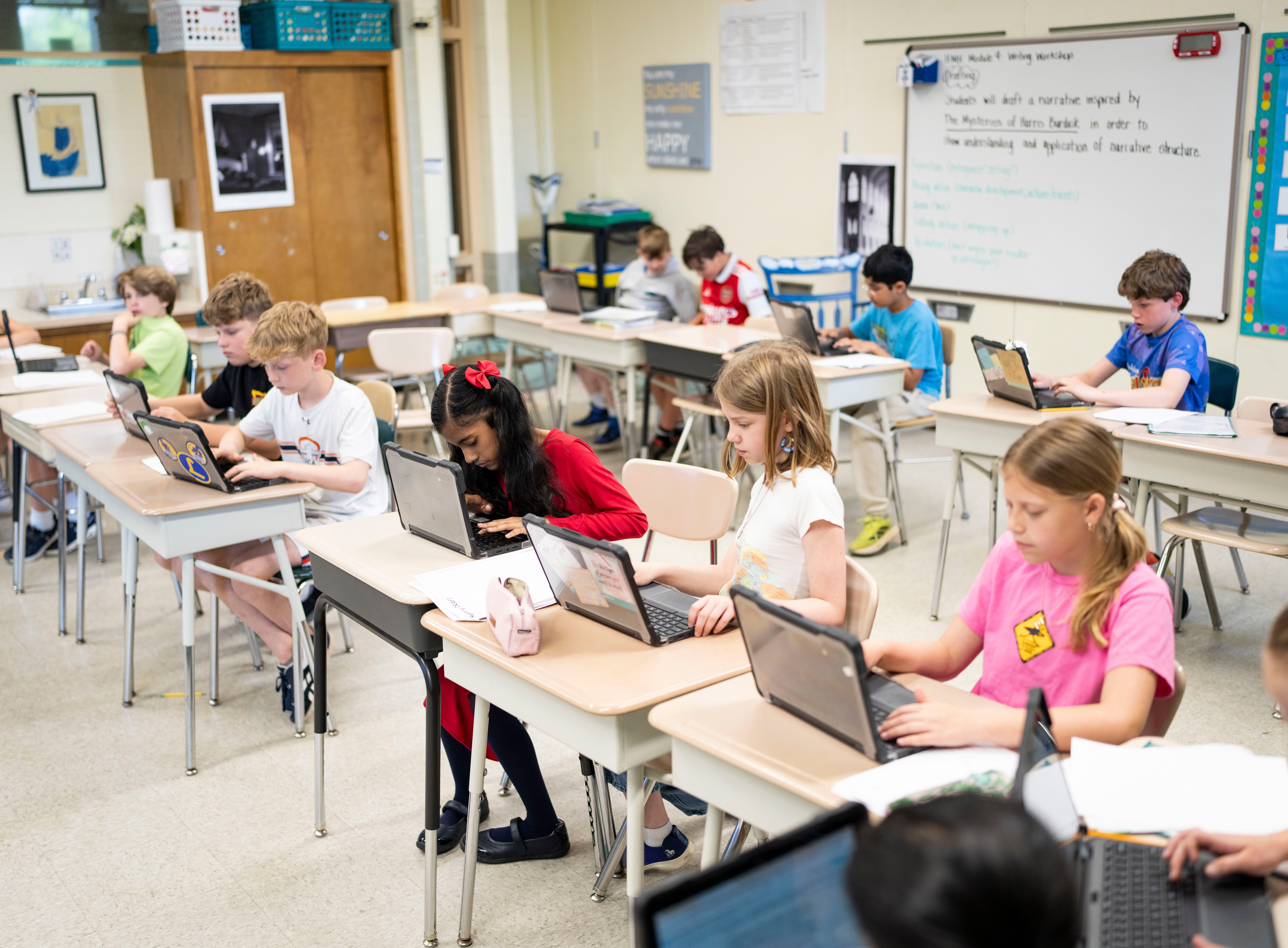 Amelia "Bindi" Ray, in red, a fifth grader at Riderwood Elementary School does school work with her classmates, in Baltimore, Thursday, May 1, 2025. Ray qualified to go to Scripps National Spelling Bee at the end of May.