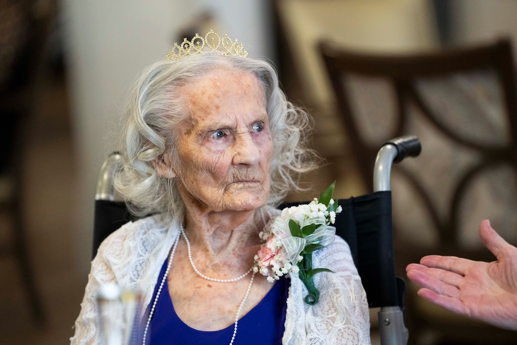 Lois Shirleymae Herron, 102, sits with her family during her birthday party.
