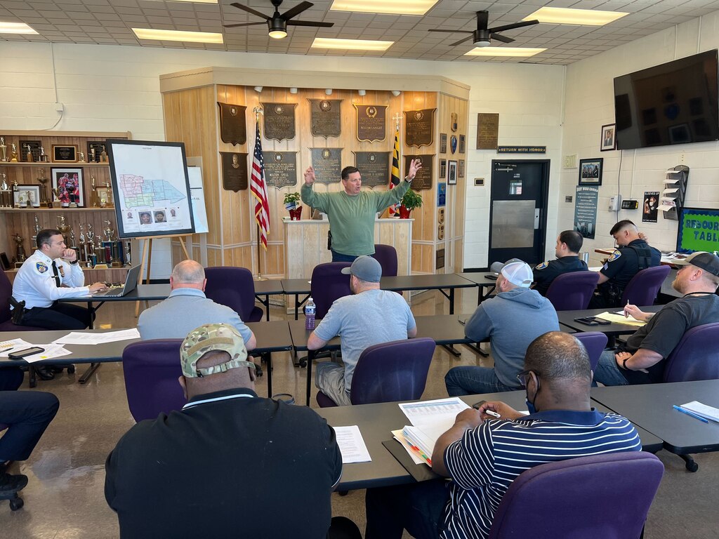Eastern District Maj. Guy Thacker addresses supervisors at a weekly intelligence meeting in the roll call room. After a “brutal” week of violence, Thacker laid out where officers should be patrolling in hopes of quelling further shootings.
