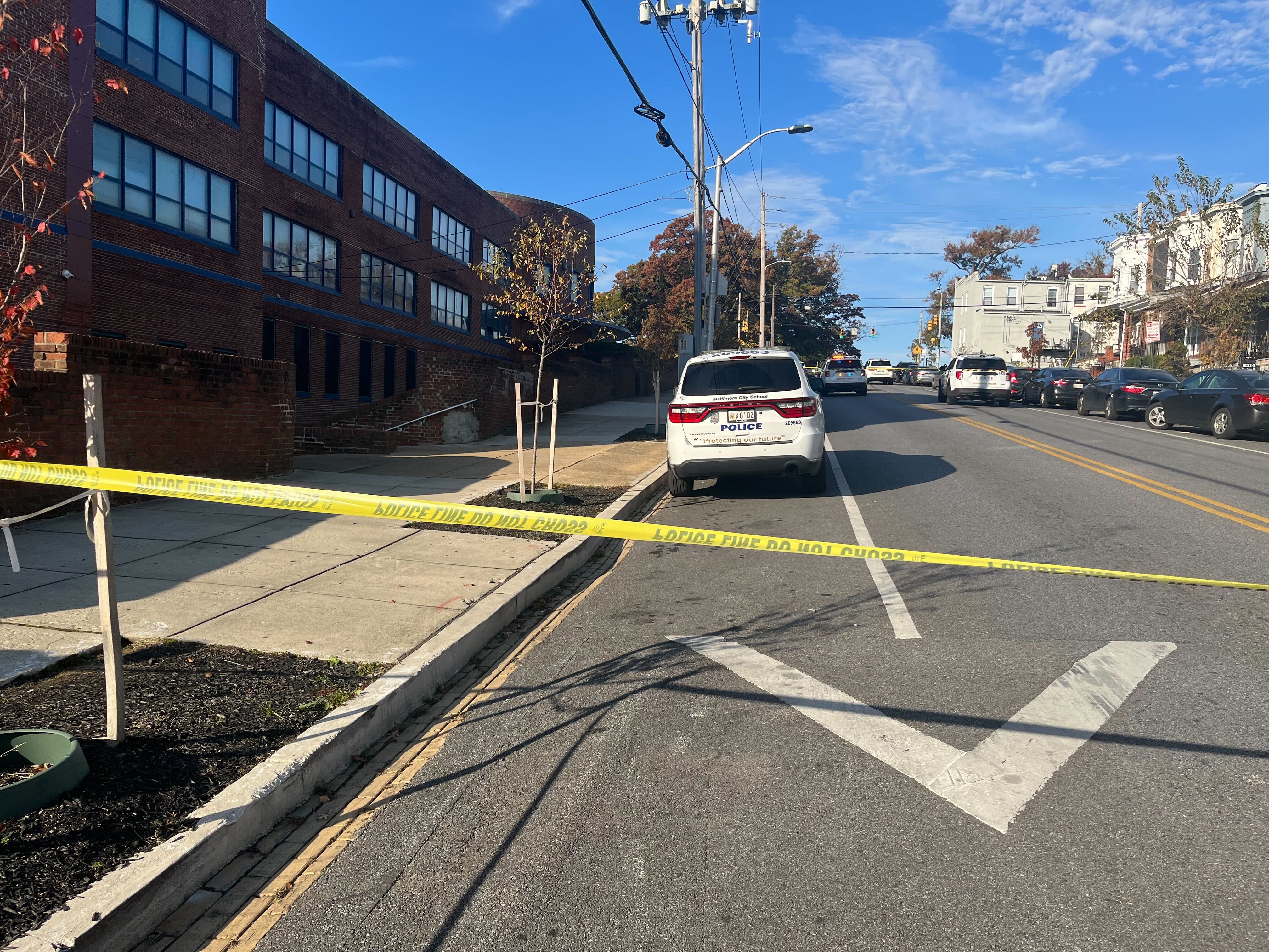 The street outside Carver Vocational-Technical High School with police tape in front.