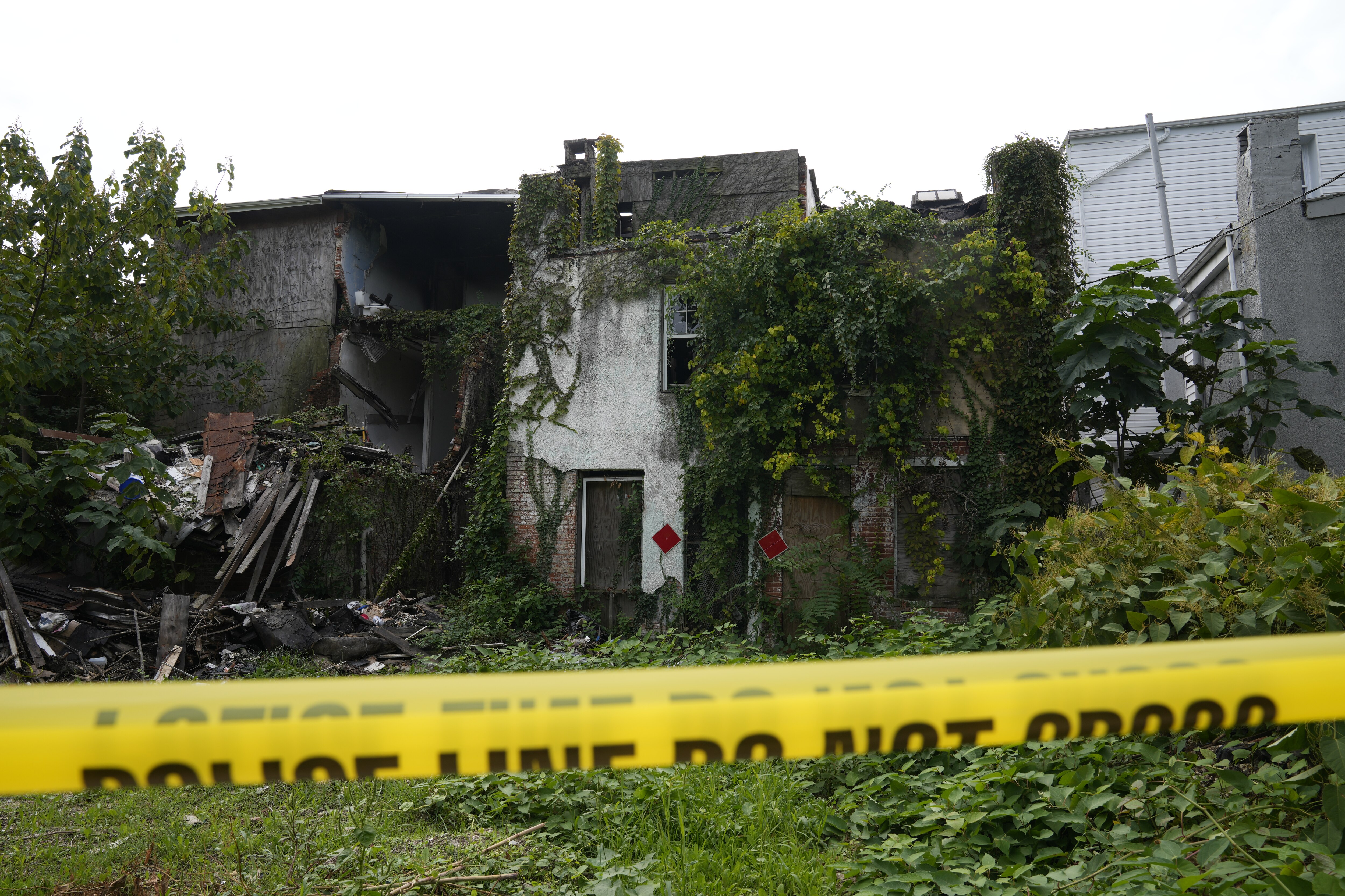 Police tape blocks off the back of 842 Edmonson Ave.