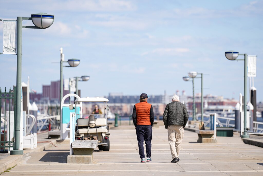 Two men walk down the dock at Harborview Marina in Baltimore, Md. on Wednesday, March 26, 2025.