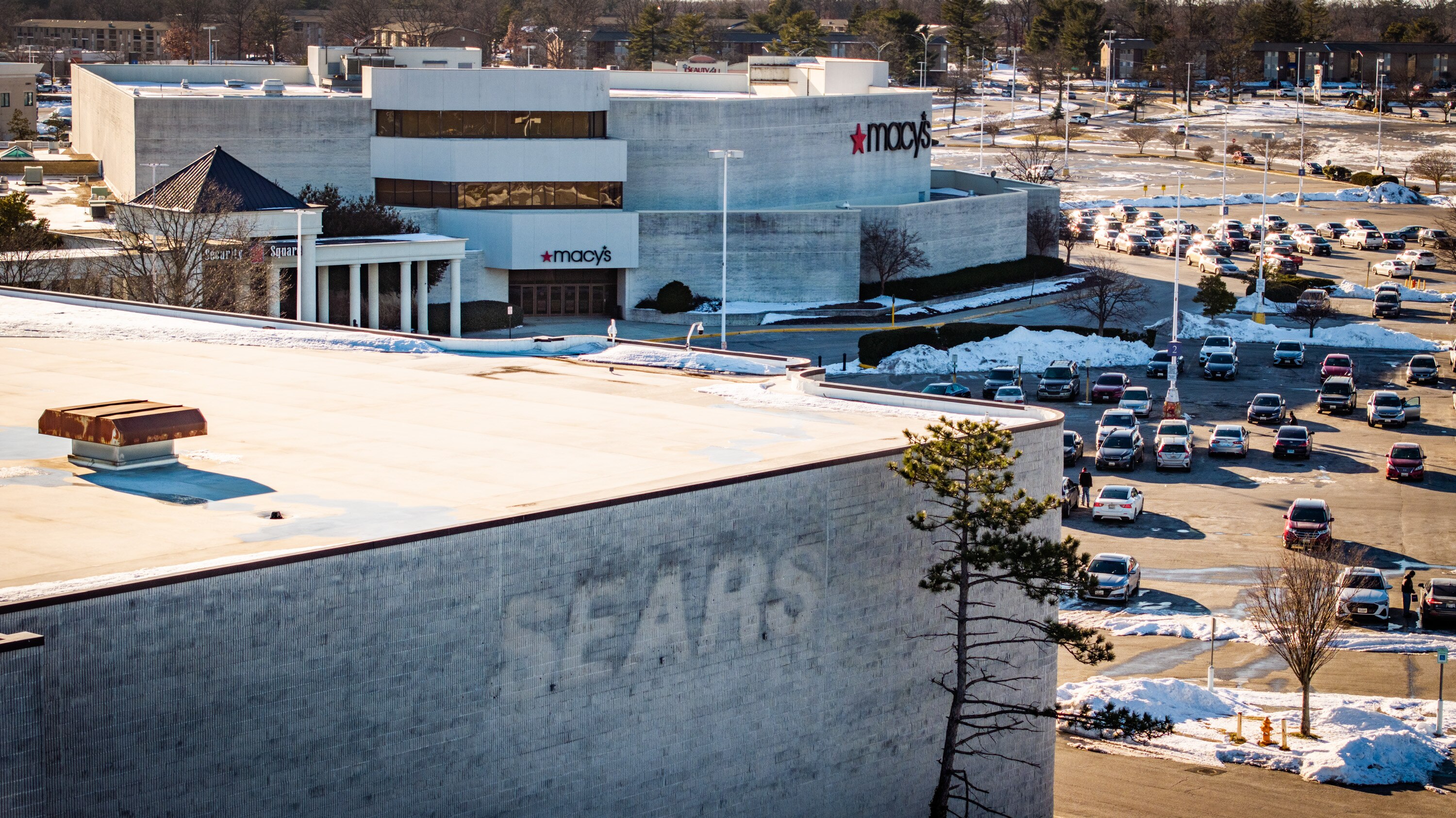 Macy’s at Security Square Mall in Woodlawn is seen beyond the remnants of a sign on the former Sears department store.
