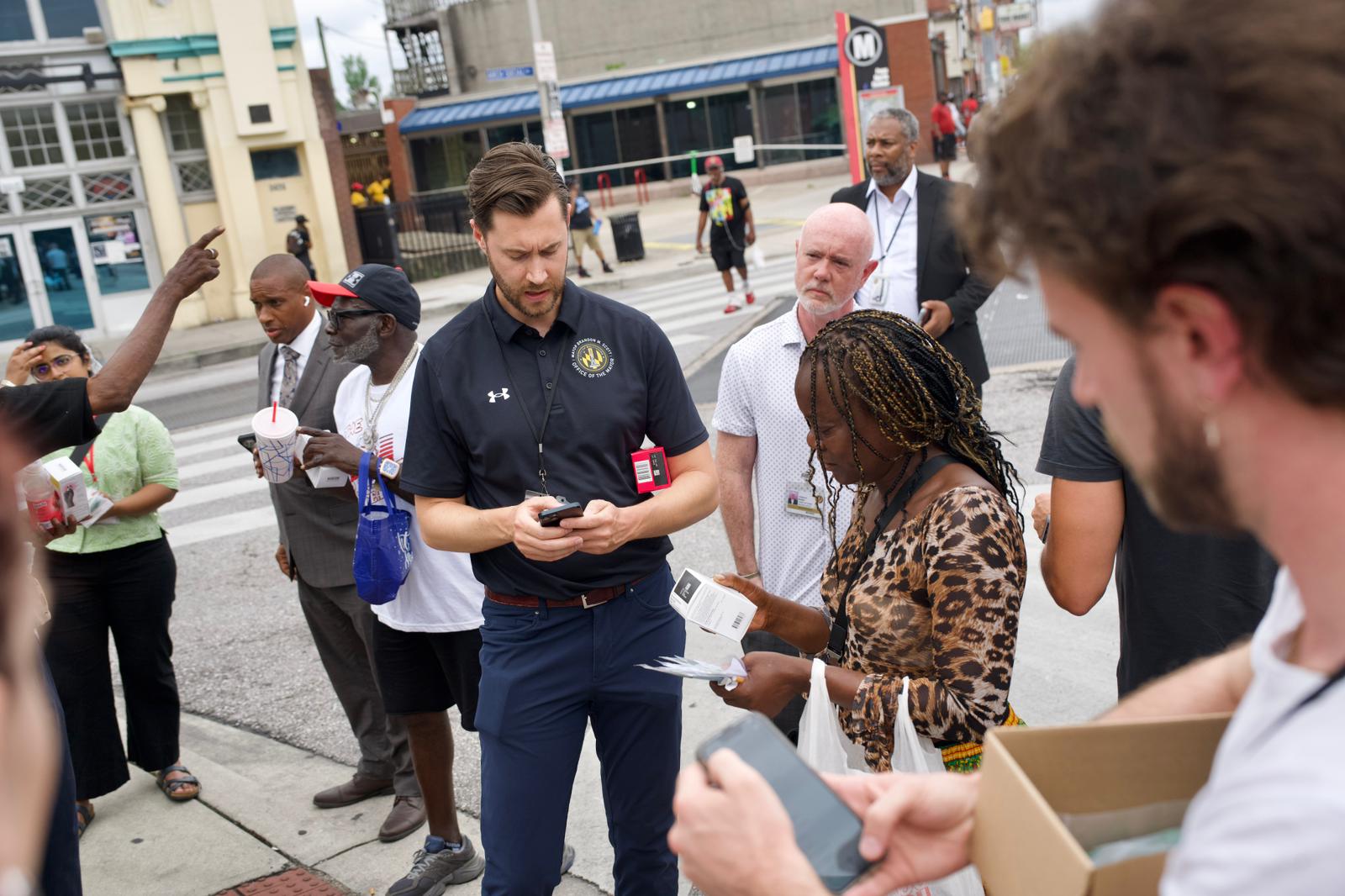 J.D. Merrill, Deputy Chief of Staff to Mayor Brandon M. Scott, distributes Narcan at the intersection of Pennsylvania and North Avenues after first responders arrived to address a call about multiple people experiencing overdose symptoms on Thursday, July 10, 2025.