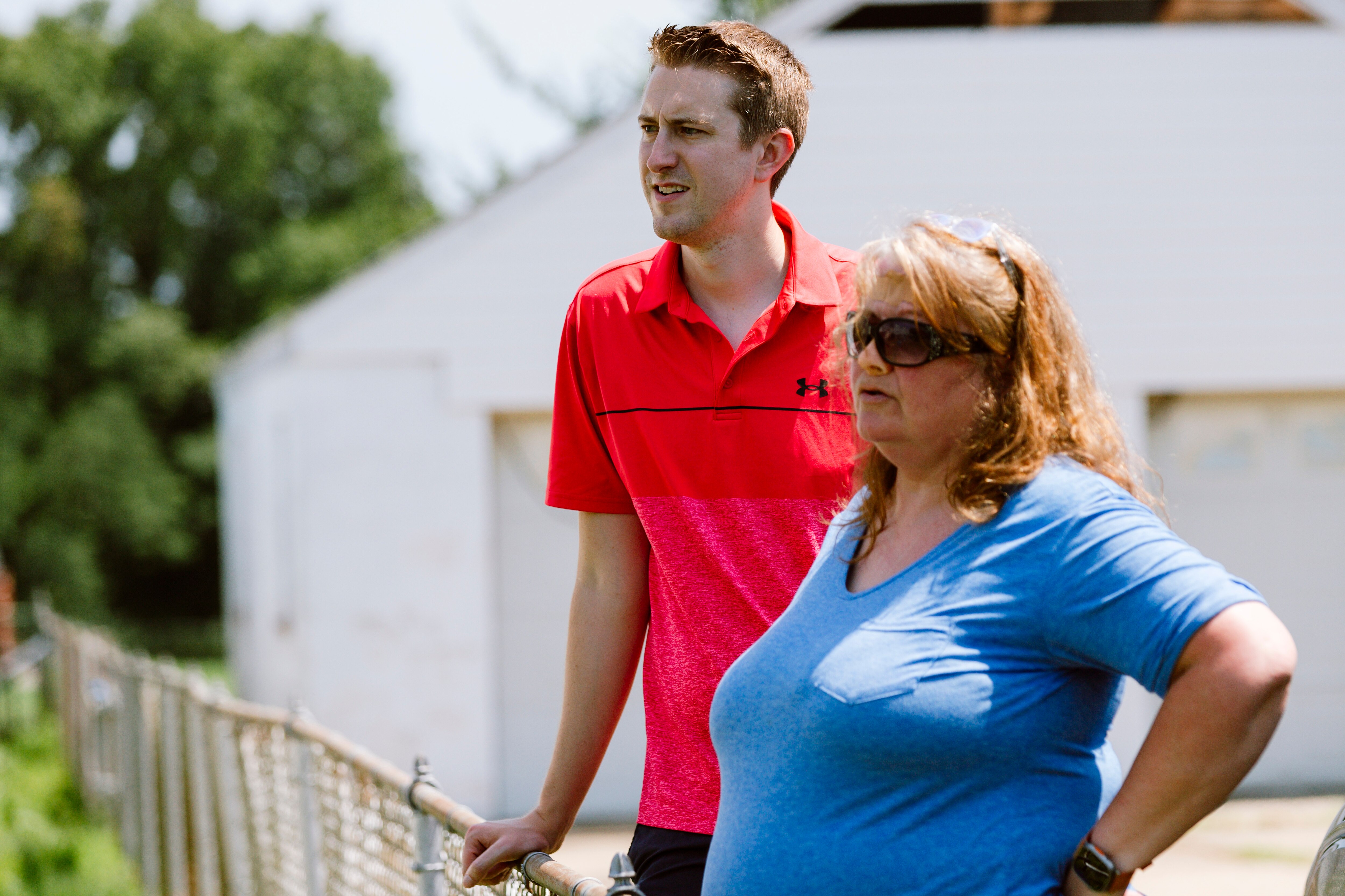Kevin McDonough, left, and Leah Biddinger speak with neighbors who dislike living next to an abandoned house on Margaret Avenue.