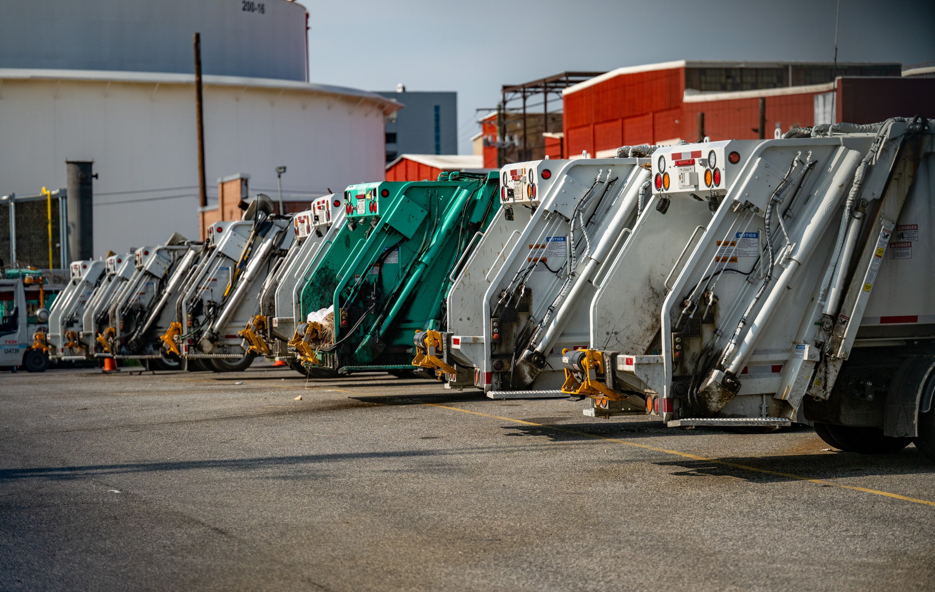 Baltimore city garbage trucks are seen parked in a lot at 1727 S. Clinton Street.