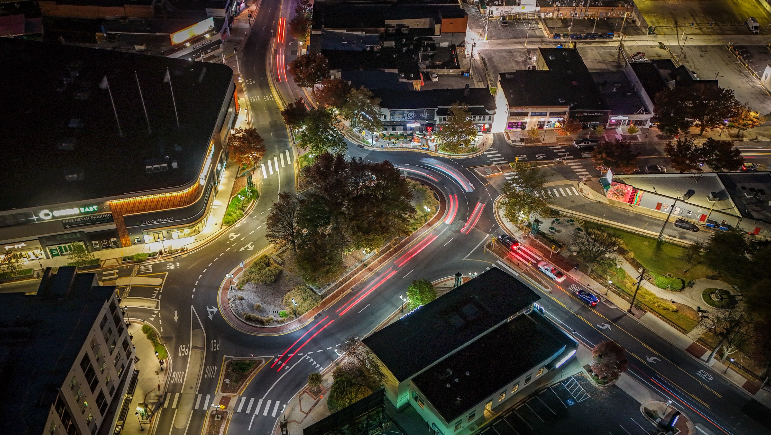 Traffic passes through the traffic circle in downtown Towson. Parking has always been challenging on the streets near the circle; a plan to extend the hours when patrons must pay for parking is not expected to go over well with businesses there.
