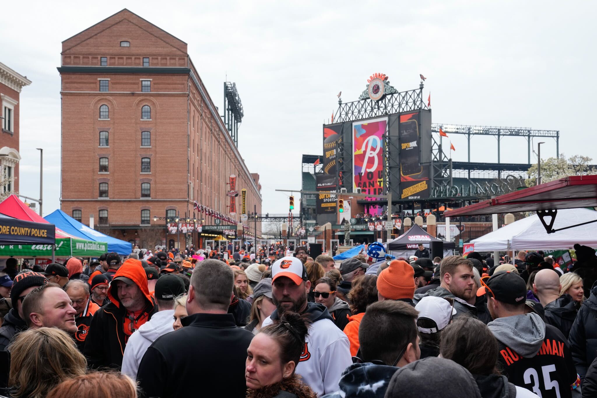 People pack a block party of vendors and music at Eutaw and Camden streets on opening day last season.