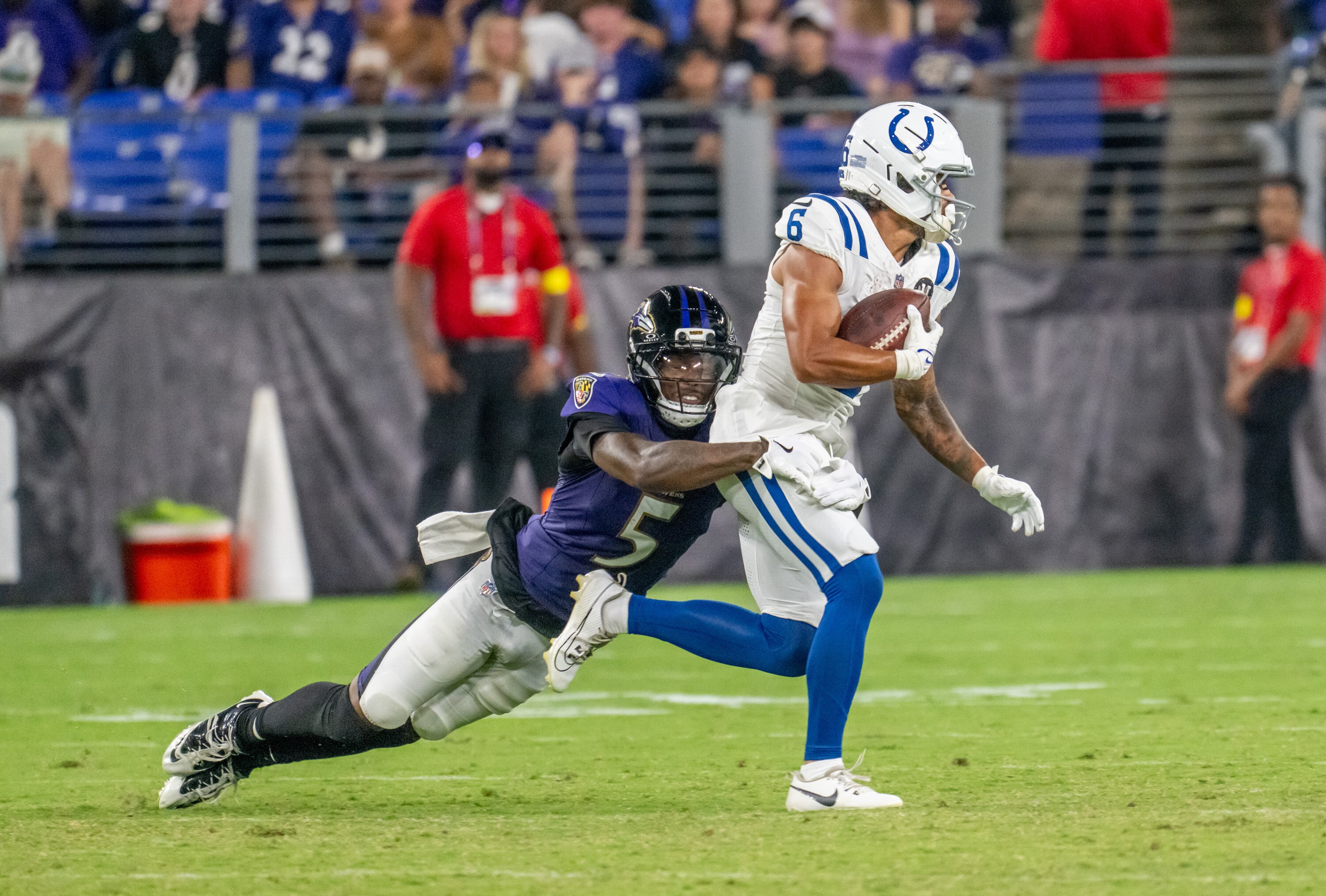 Cornerback Jalyn Armour-Davis (5) wraps up wide receiver Anthony Gould (6) in the Ravens' preseason game against the Colts on Aug. 7.