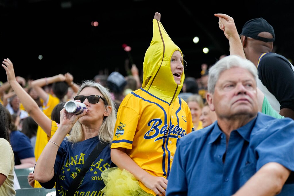A Savannah Bananas fan is dressed in a banana costume during a Banana Ball game against The Firefighters at Oriole Park at Camden Yards in Baltimore, Md. on Friday, August 1, 2025. It’s the first of two games to be played at Camden Yards this weekend.