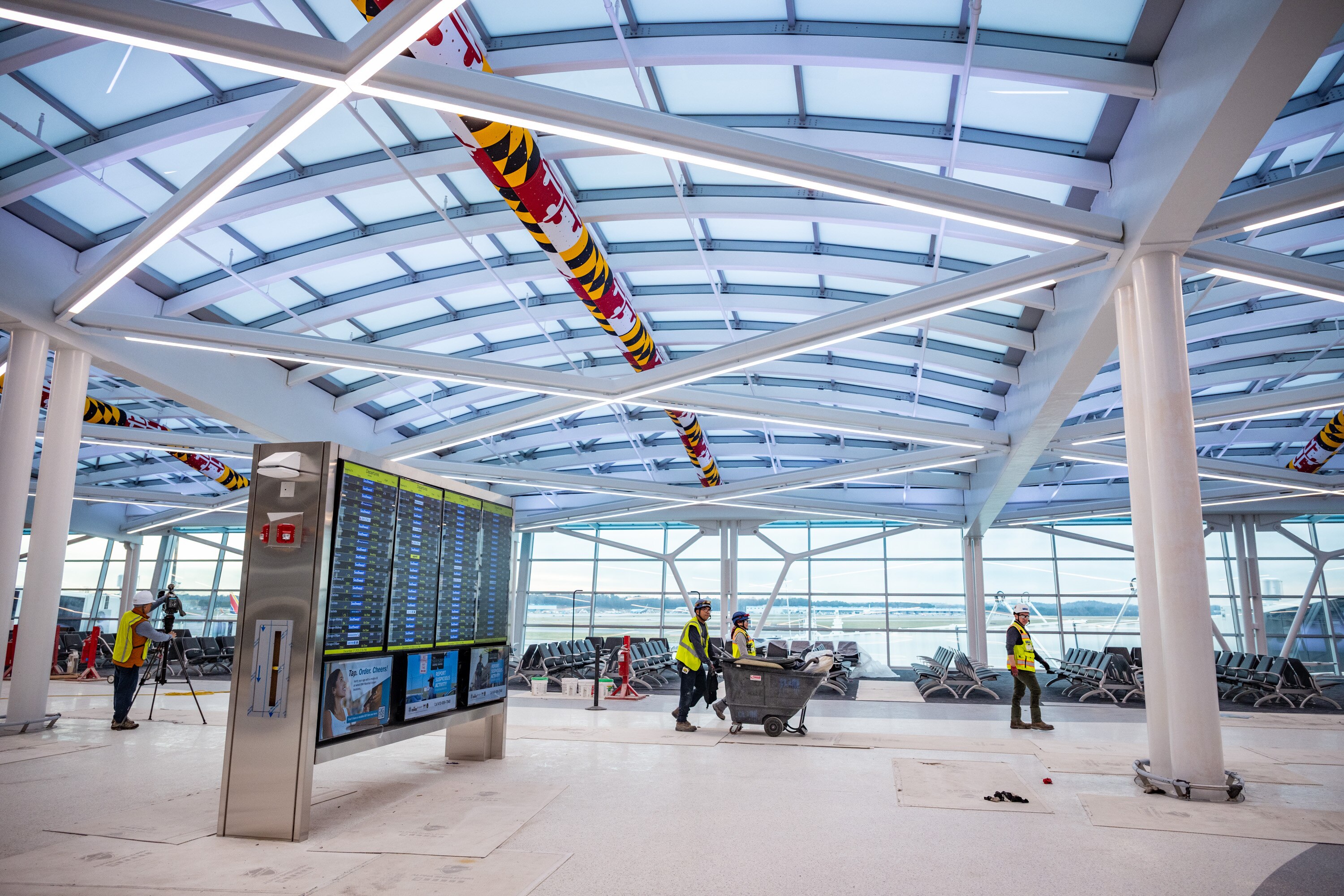 Contractors walk through Baltimore-Washington International Thurgood Marshall Airport while working on the airport's new terminal expansion project.