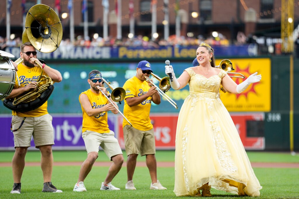 The Savannah Bananas’ Princess Potassium dances with the band during a pre-game show ahead of a Banana Ball game between the Bananas and The Firefighters at Oriole Park at Camden Yards in Baltimore, Md. on Friday, August 1, 2025. It’s the first of two games to be played at Camden Yards this weekend.