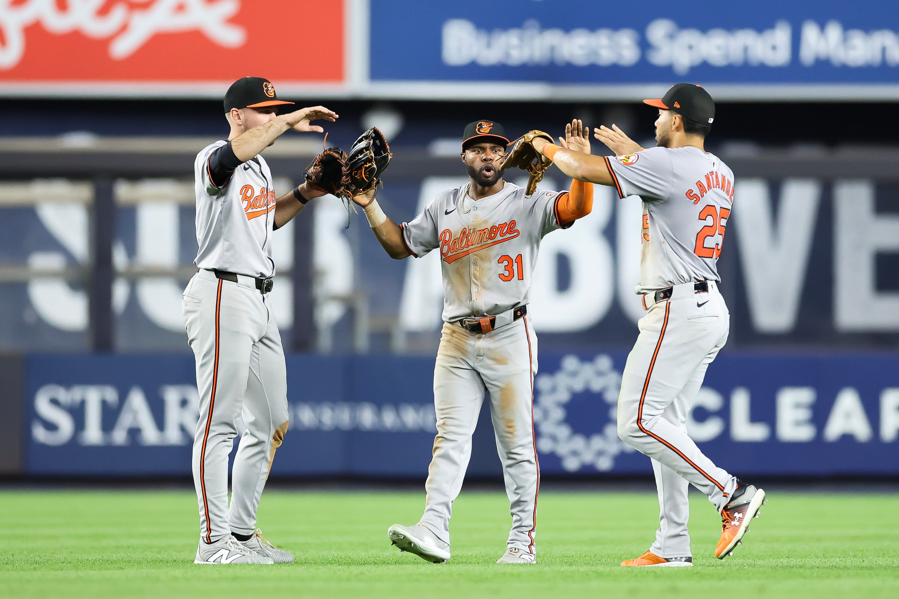 Outfielders Colton Cowser (left), Cedric Mullins (center) and Anthony Santander congregate after the Orioles beat New York on Wednesday at Yankee Stadium.