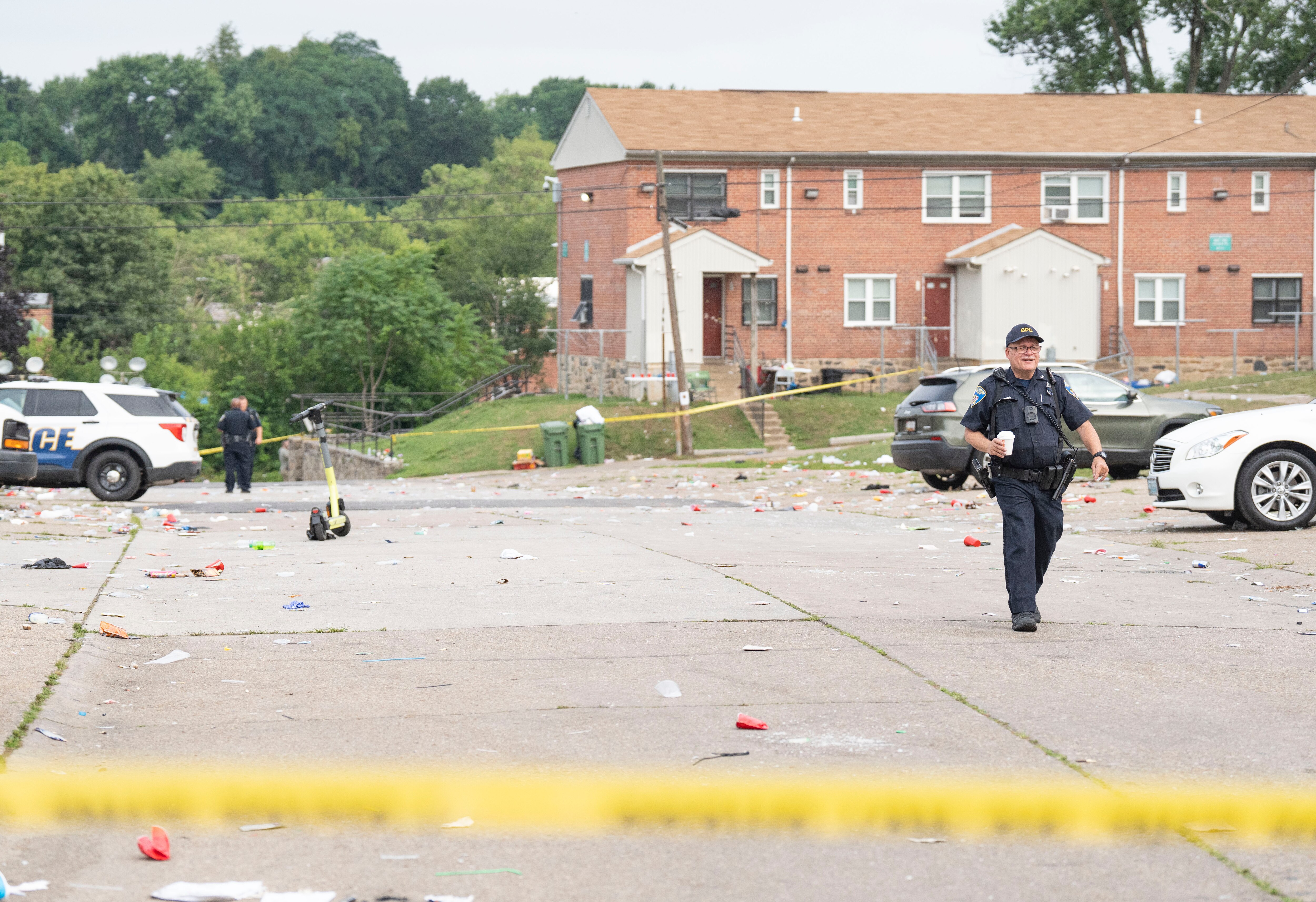 8:28 AM a police officer walks through the crime scene on Elarton Ct. in Brooklyn following a shooting, Sunday, July 2, 2023.