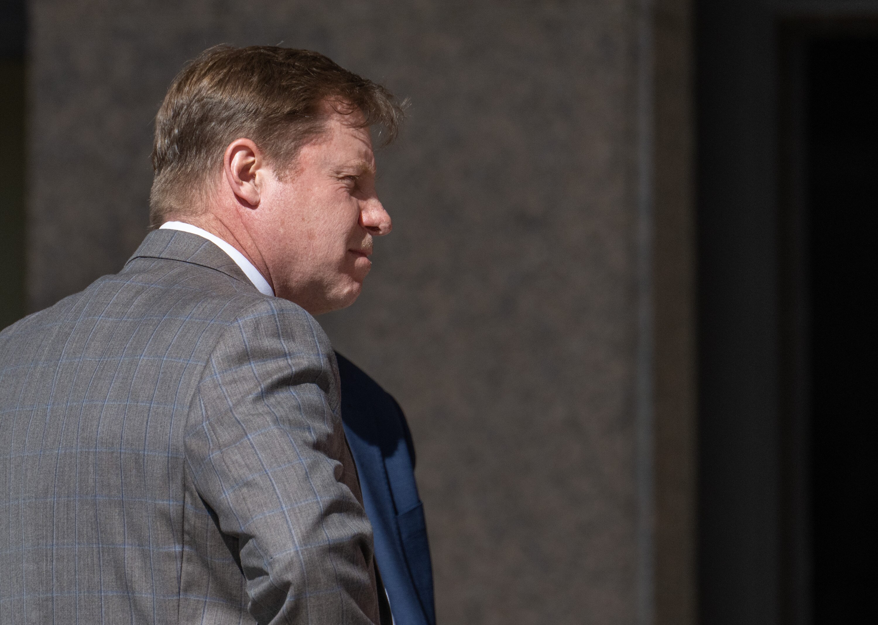 Eric Eiswert, former principal of Pikesville High School, talks to his lawyers outside the Baltimore County Courthouse after Dazhon Darien, the man accused of using artificial intelligence to impersonate him took a plea deal.