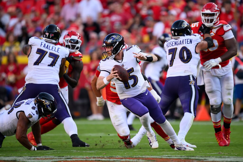 Baltimore Ravens quarterback Cooper Rush (15) scrambles away from pressure by the Kansas City Chiefs during the second half of an NFL football game, Sunday, Sept. 28, 2025 in Kansas City, Mo.