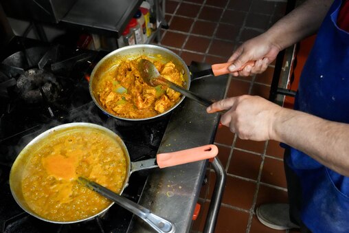 Head chef Gurnek Bassi prepares an order of dahl makhani in the kitchen at India Tandoor in Baltimore, Md. on Wednesday, March 19, 2025. The small Indian restaurant is located in the back of a convenience store in Baltimore’s Remington neighborhood.