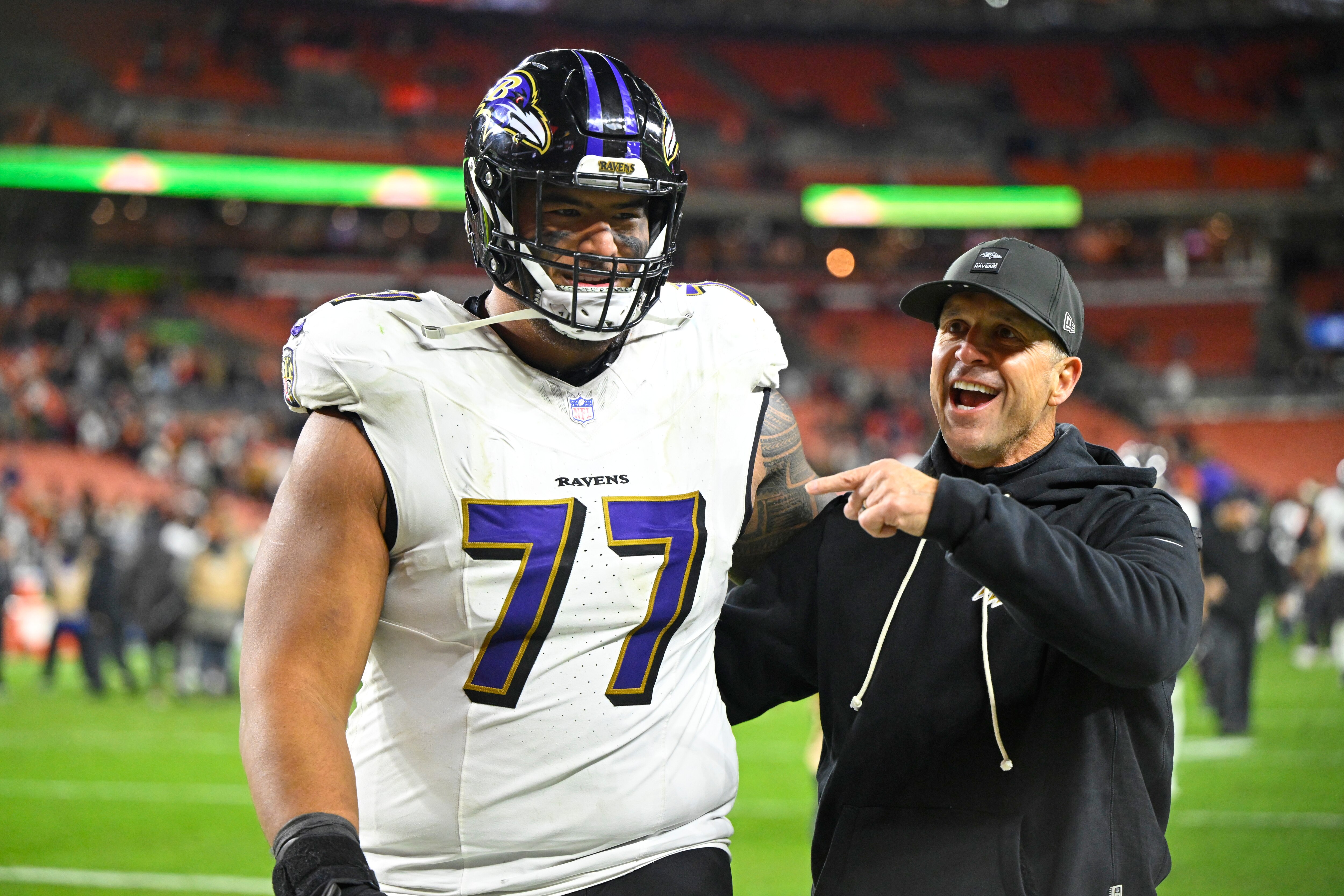 Ravens coach John Harbaugh, right, walks of the field with guard Daniel Faalele (77) after the Ravens beat the Browns 23-16.