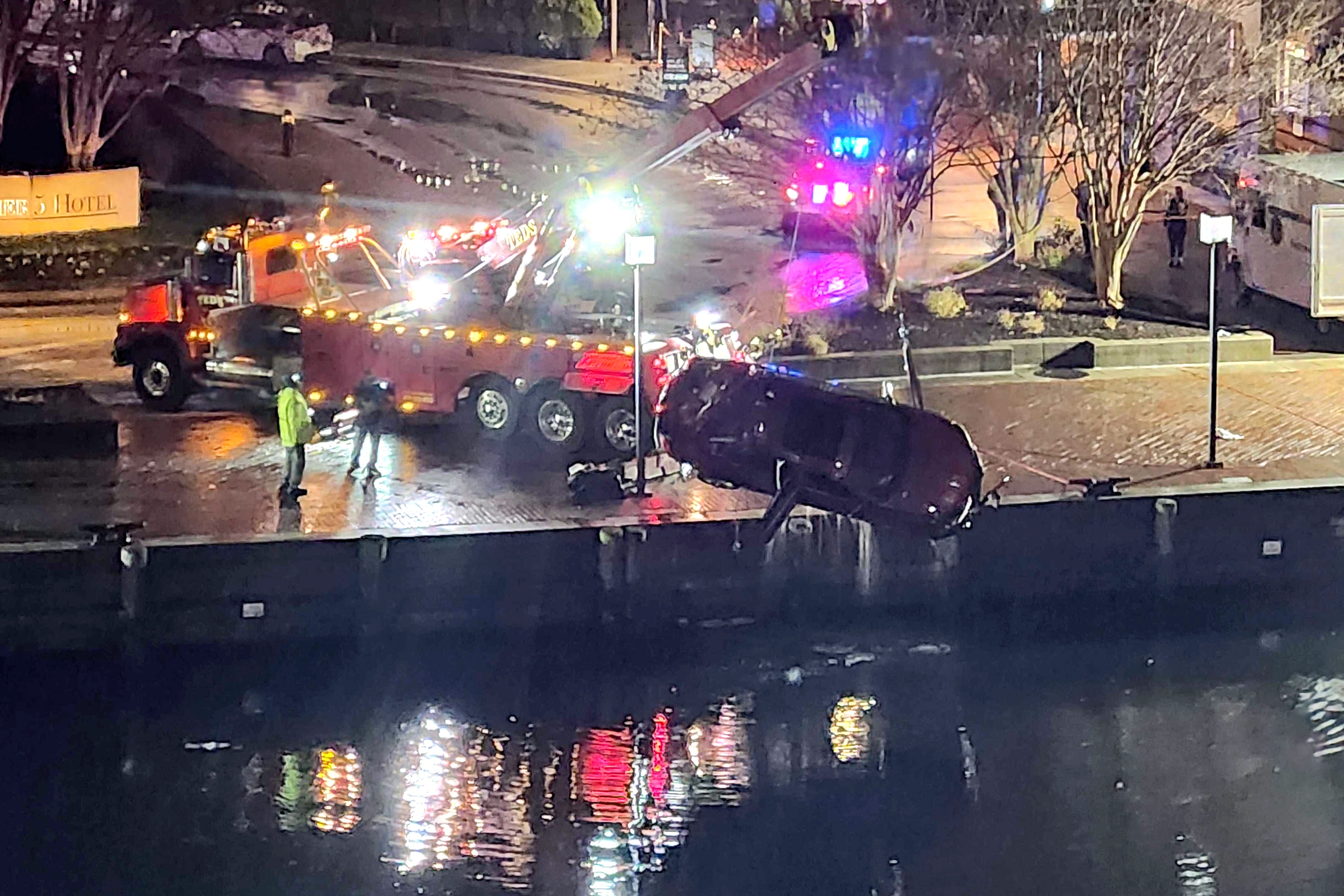 TUESDAY, NOVEMBER 18, 2025 - Crews work to retrieve a car from the Inner Harbor on Tuesday evening after more than a dozen Baltimore fire trucks and police cars lined the area near the Pier 5 Hotel as a vehicle plunged into the water.