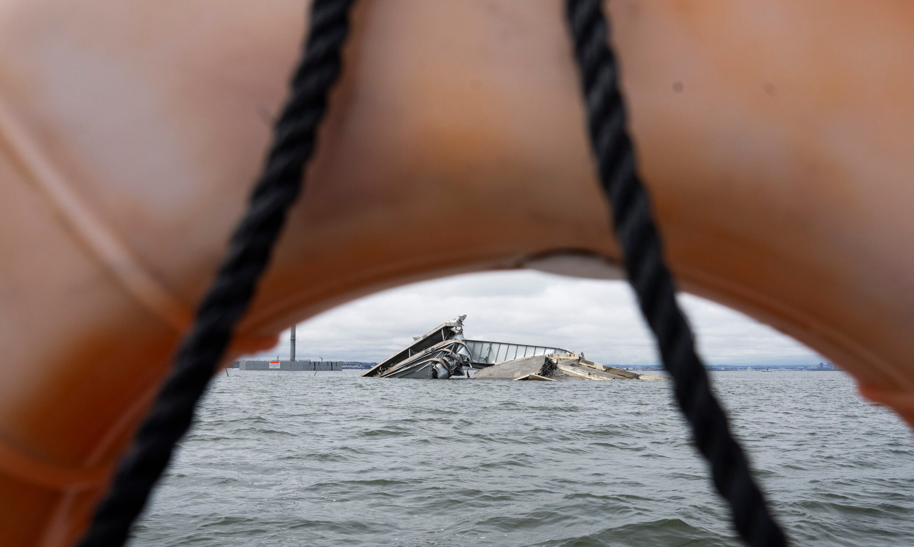 Remains of the Francis Scott Key Bridge can be seen on April 1 in the Patapsco River after its collapse on March 26. A year later, work has begun on a replacement bridge.