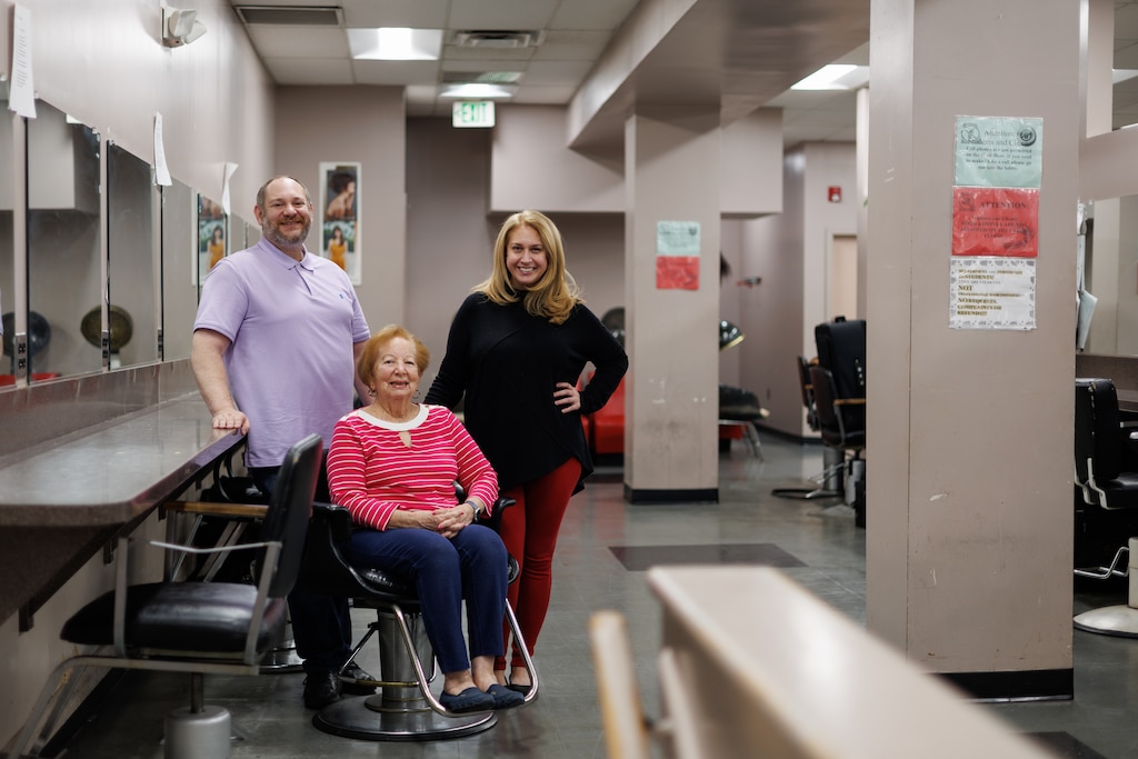 Justin, Maxine, and Samara Sisserman pose for a photo inside the Baltimore Studio of Hair Design on Howard Avenue.