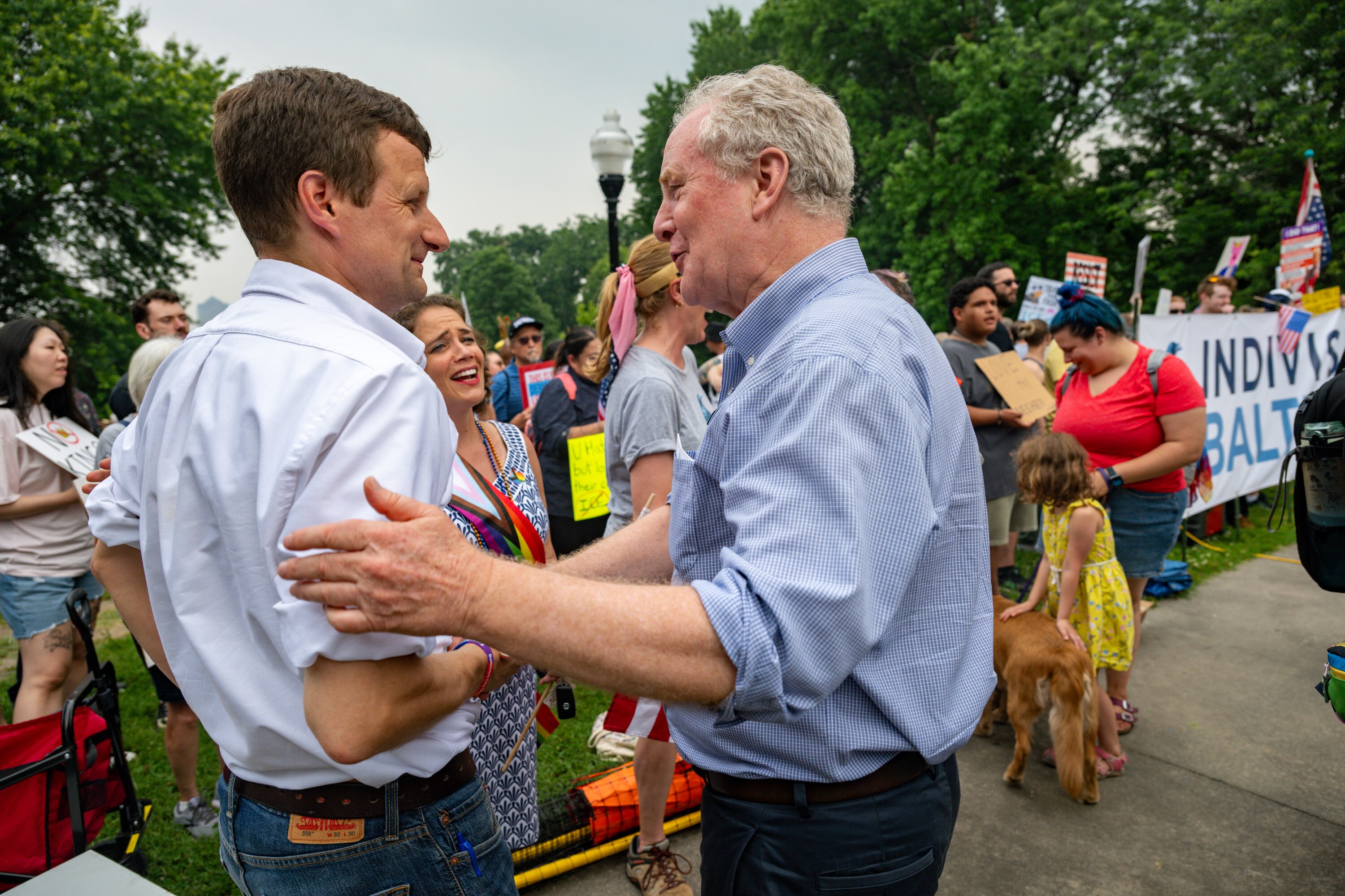 Baltimore City Councilman Mark Parker talks with Sen. Chris Van Hollen in Patterson Park during one of the many No Kings protests being held around the country in opposition to President Trump.