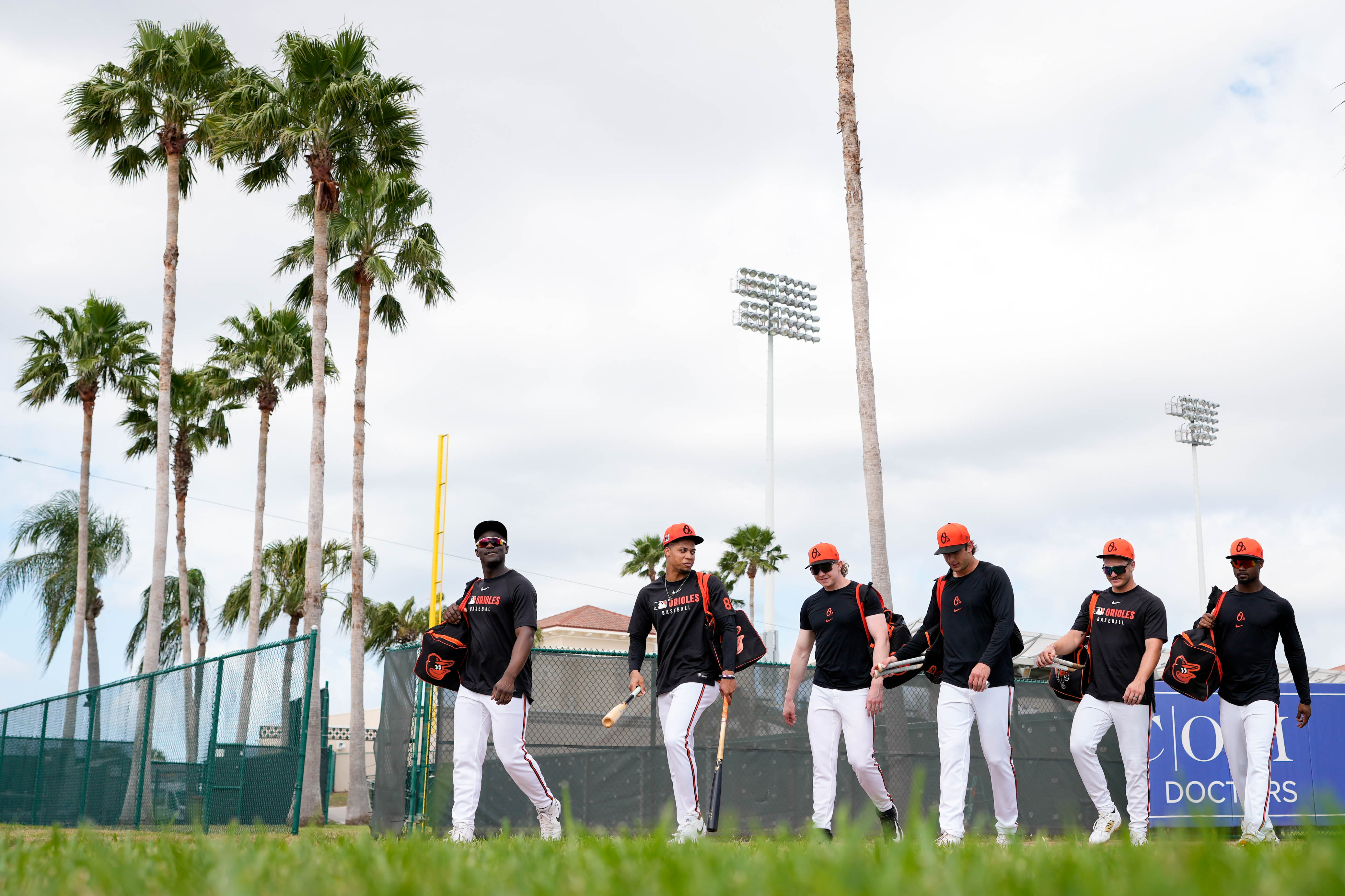 Baltimore Orioles outfielders leave the main field during Spring Training at Ed Smith Stadium in Sarasota, Fla. on Tuesday.