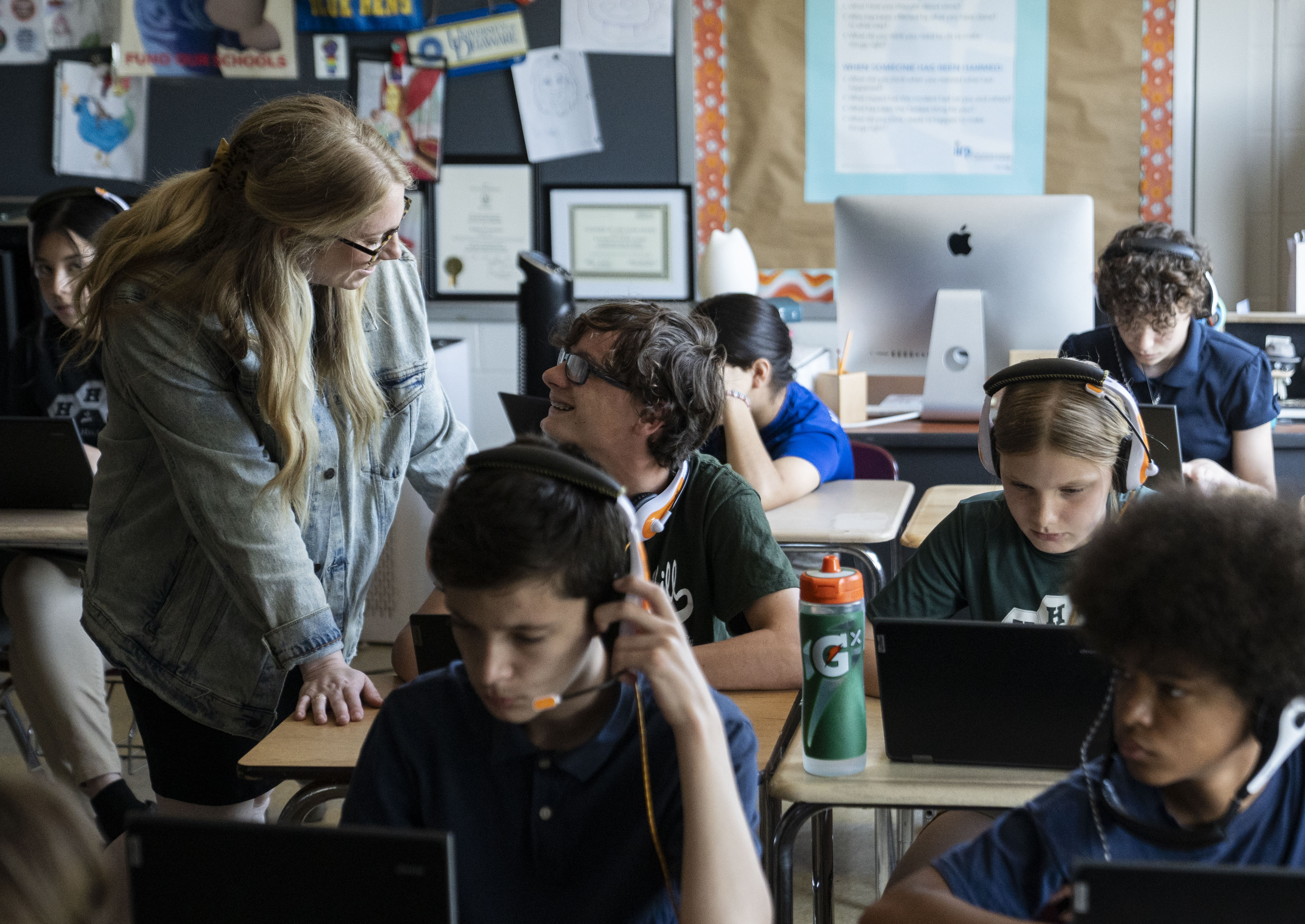 Kat Locke-Jones, a seventh-grade English teacher speaks with students during class at Hampstead Hill Academy in Baltimore.