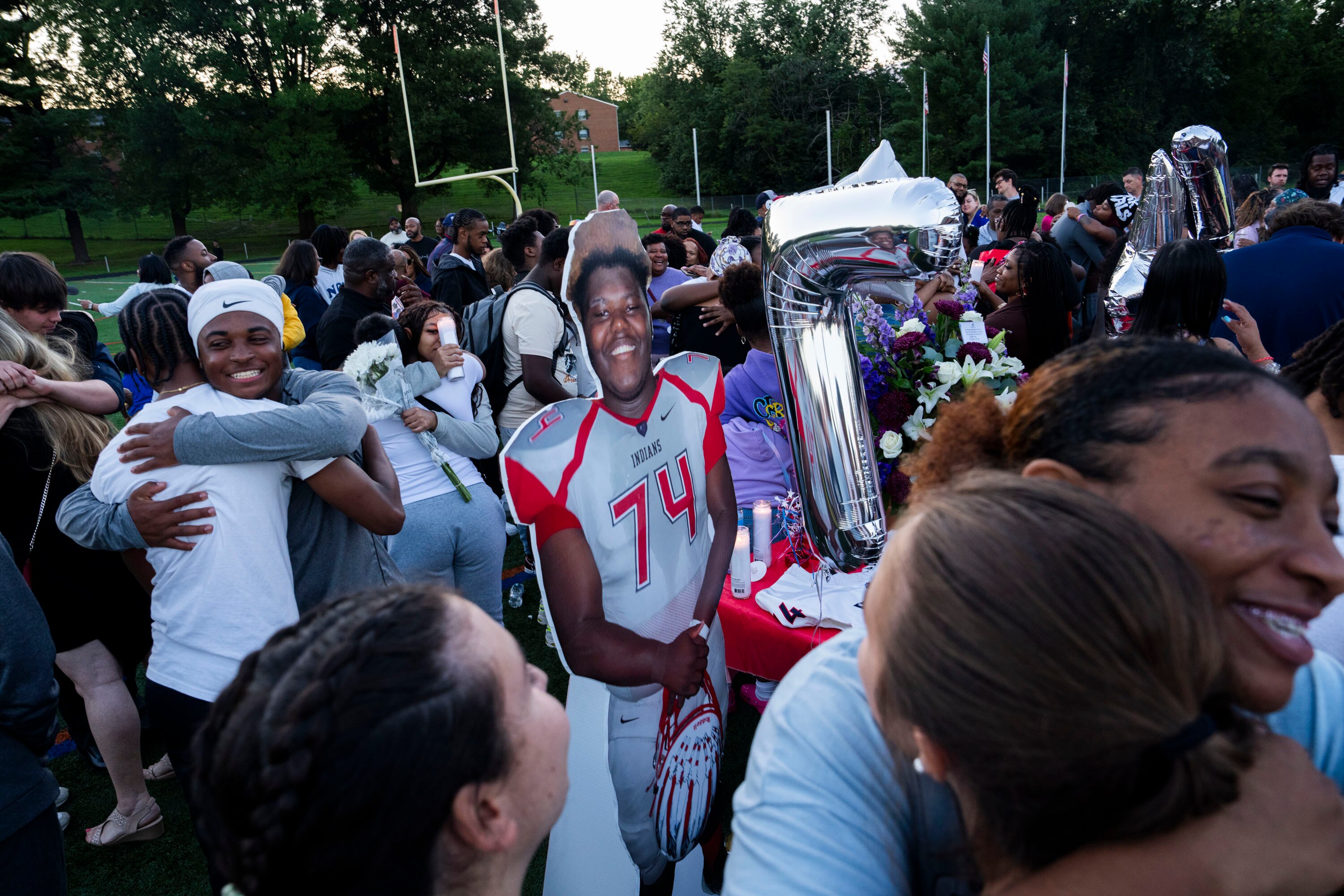 Loved ones were told to go in peace and hug someone after the vigil for 16-year-old Leslie Noble. Noble died during a football practice at Franklin High School last week. A smiling cardboard cutout of Noble was positioned in the center of the crowd.
